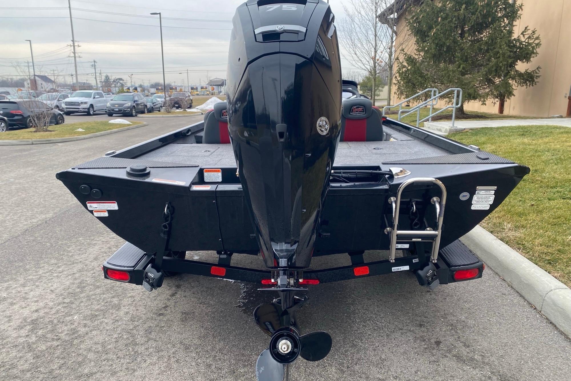 2025 Ranger RT178 boat with outboard motor, parked on a trailer in a lot.