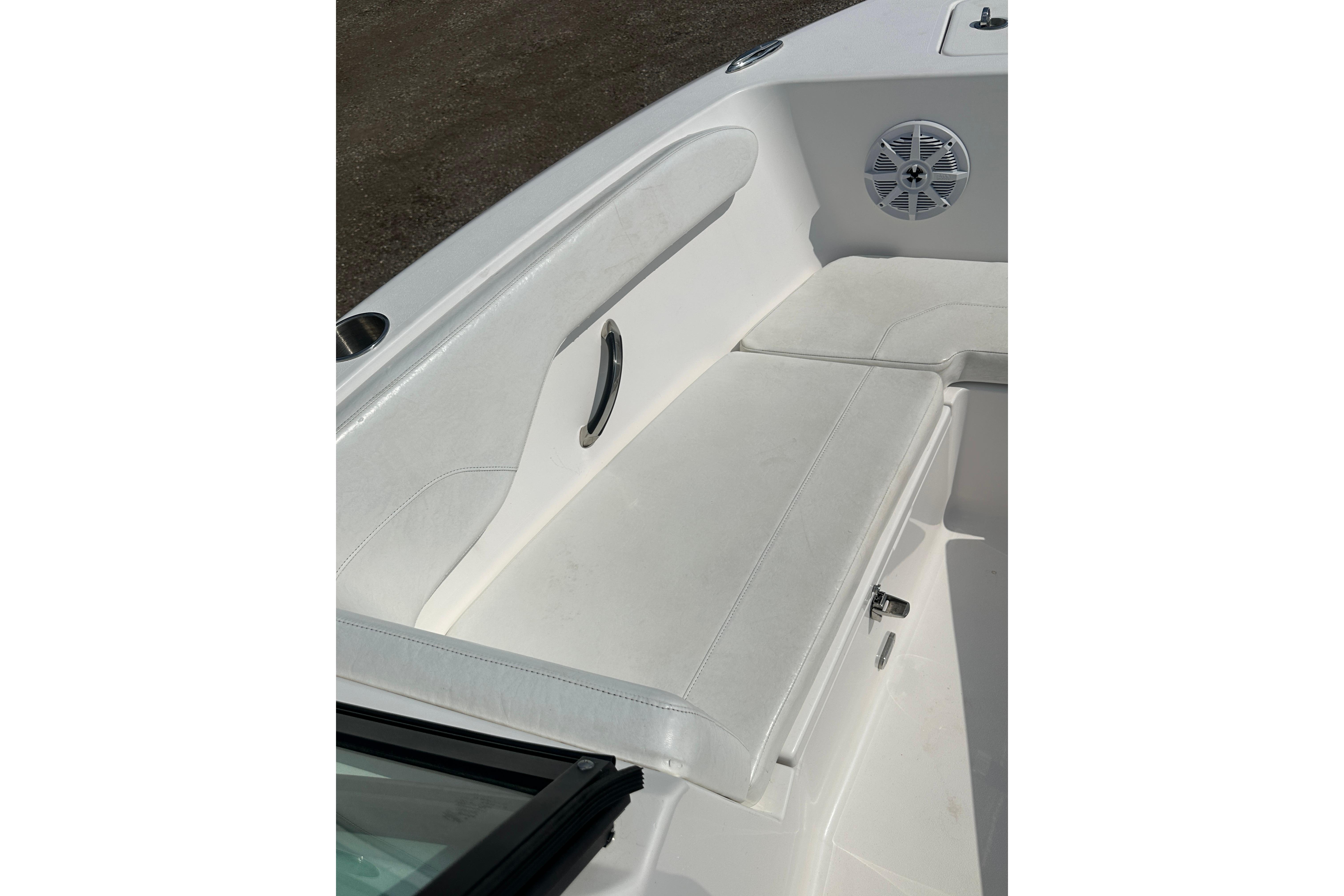2024 Aquasport 2200 Dual Console boat interior with white seating and speaker.