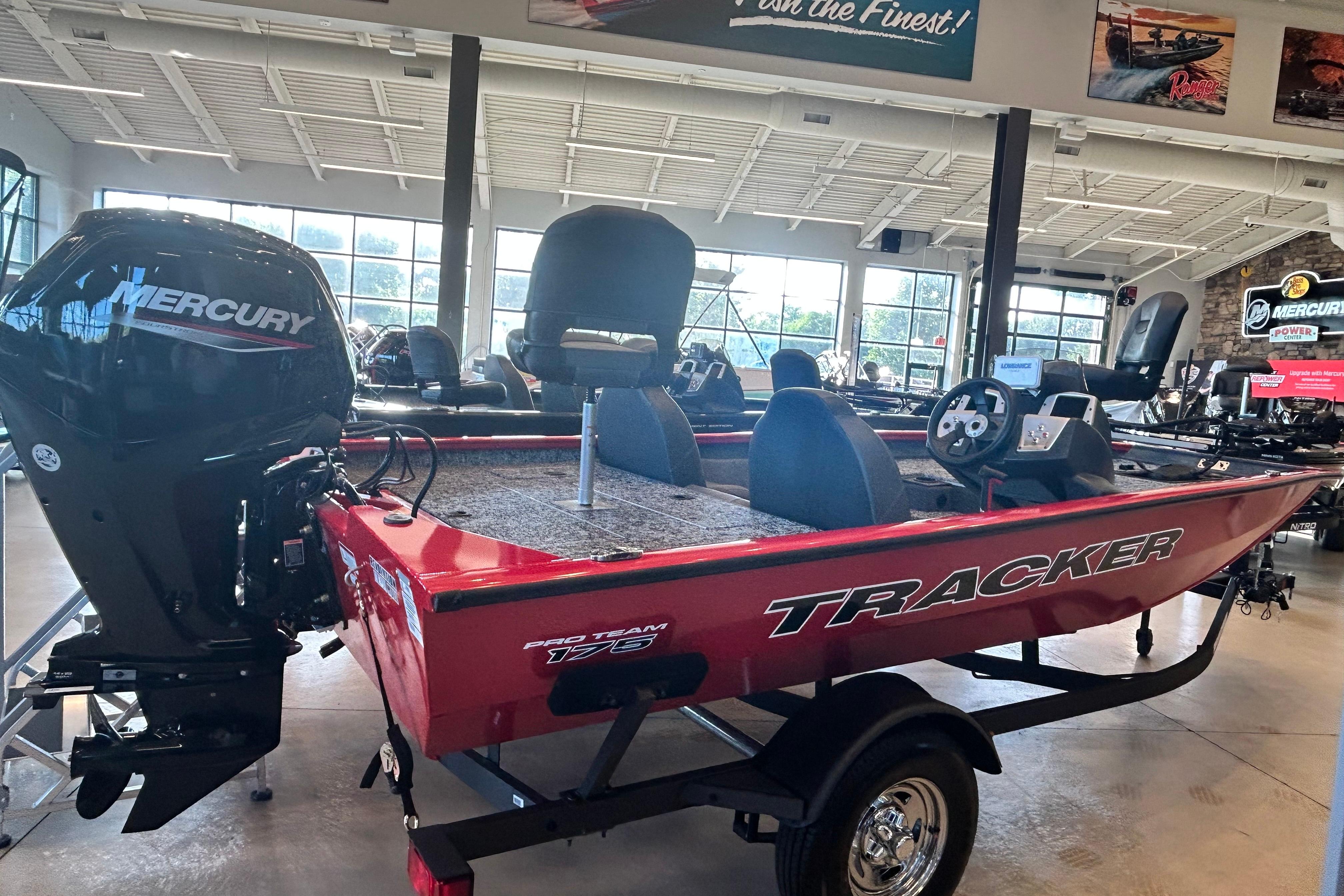 2026 Tracker Pro Team 175 boat with Mercury engine in showroom.