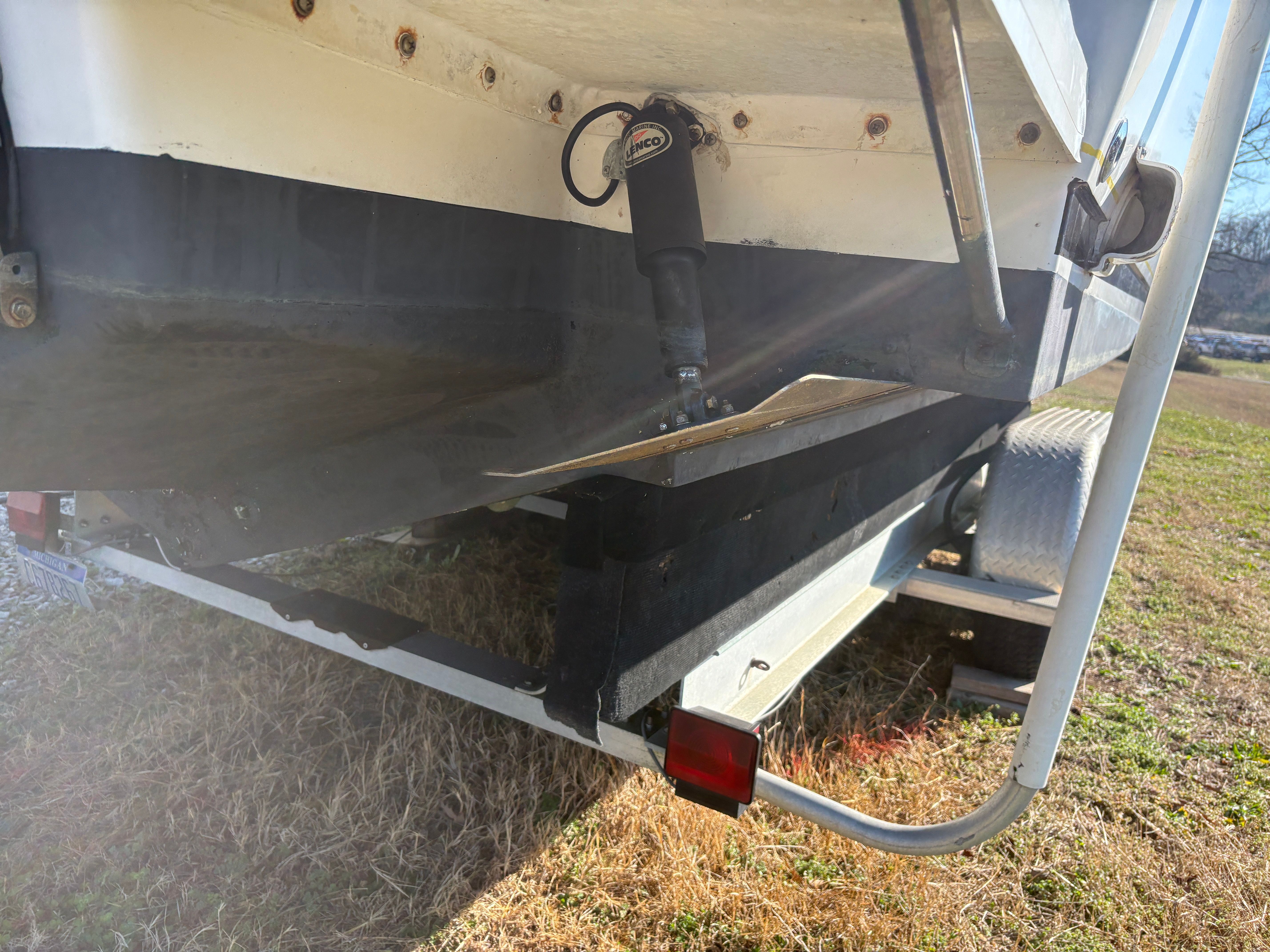 Intrepid 322 Cuddy Center Console boat on trailer, side view.