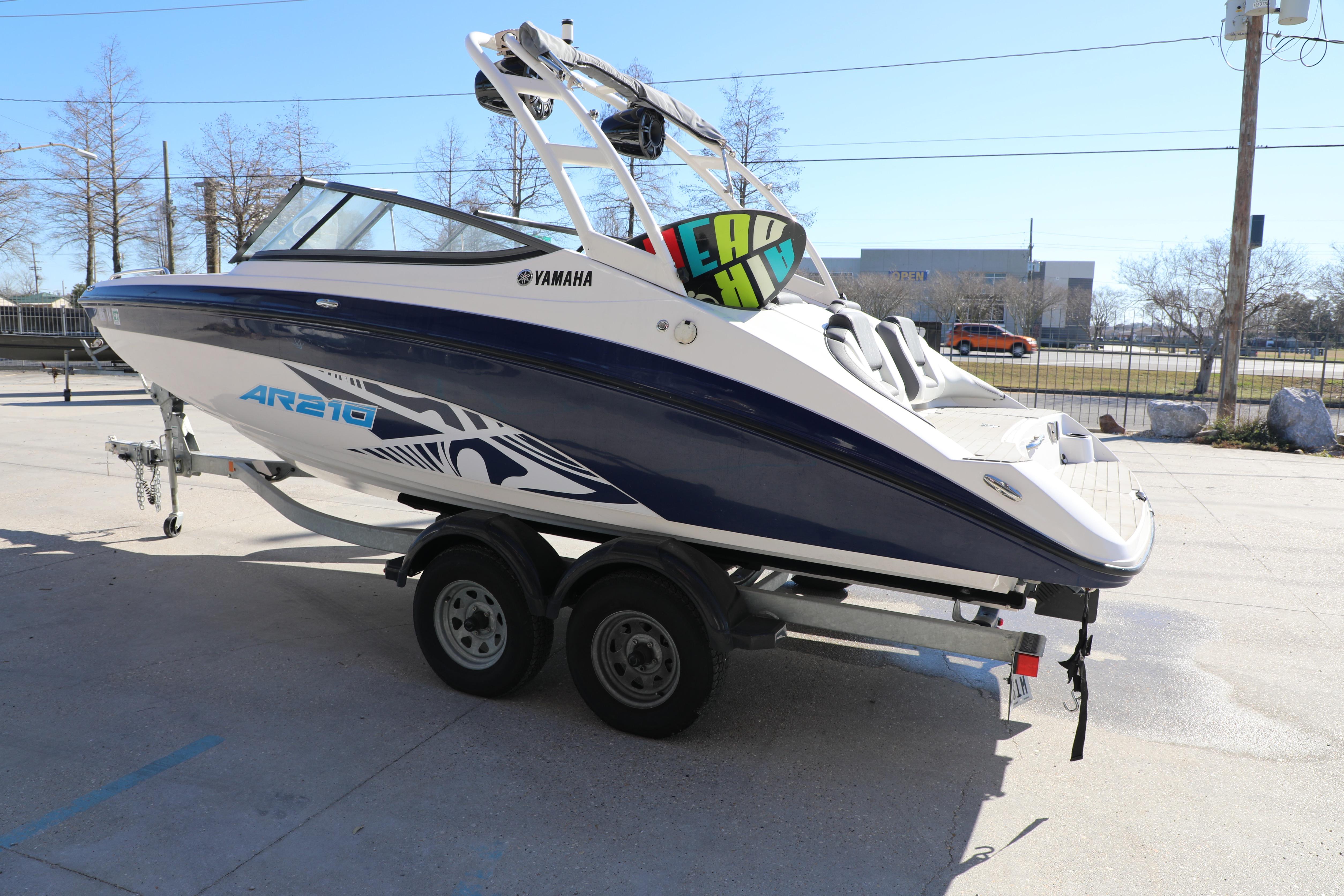 2022 Yamaha AR210 boat on trailer, sleek design, parked outdoors.