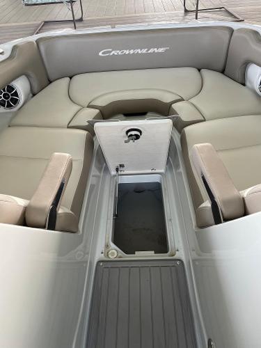 2019 Crownline E255 boat interior with beige seating and storage compartment.