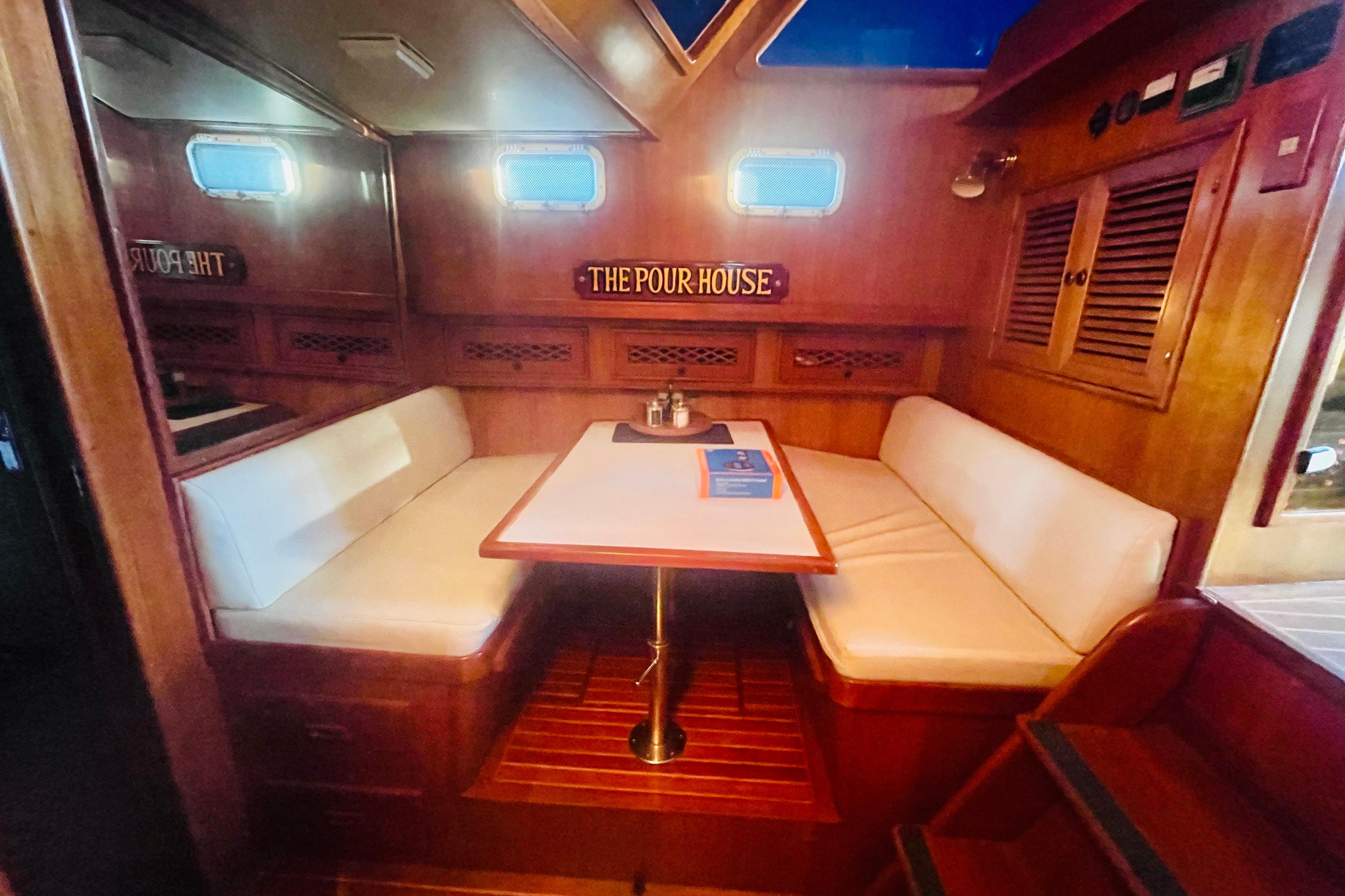 1986 Tung Hwa aft cabin interior with cozy dining area and wooden accents.