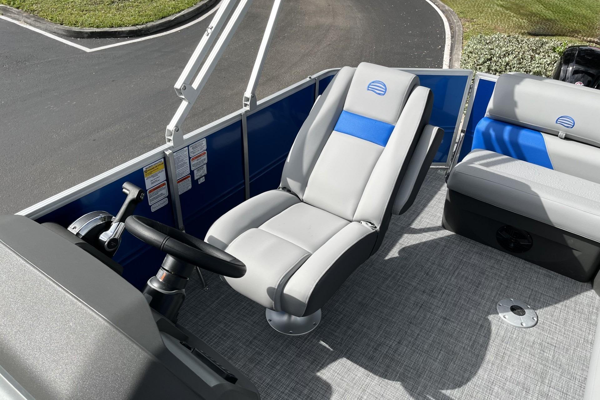 2026 Sun Tracker Party Barge 20 DLX interior with gray and blue seating.