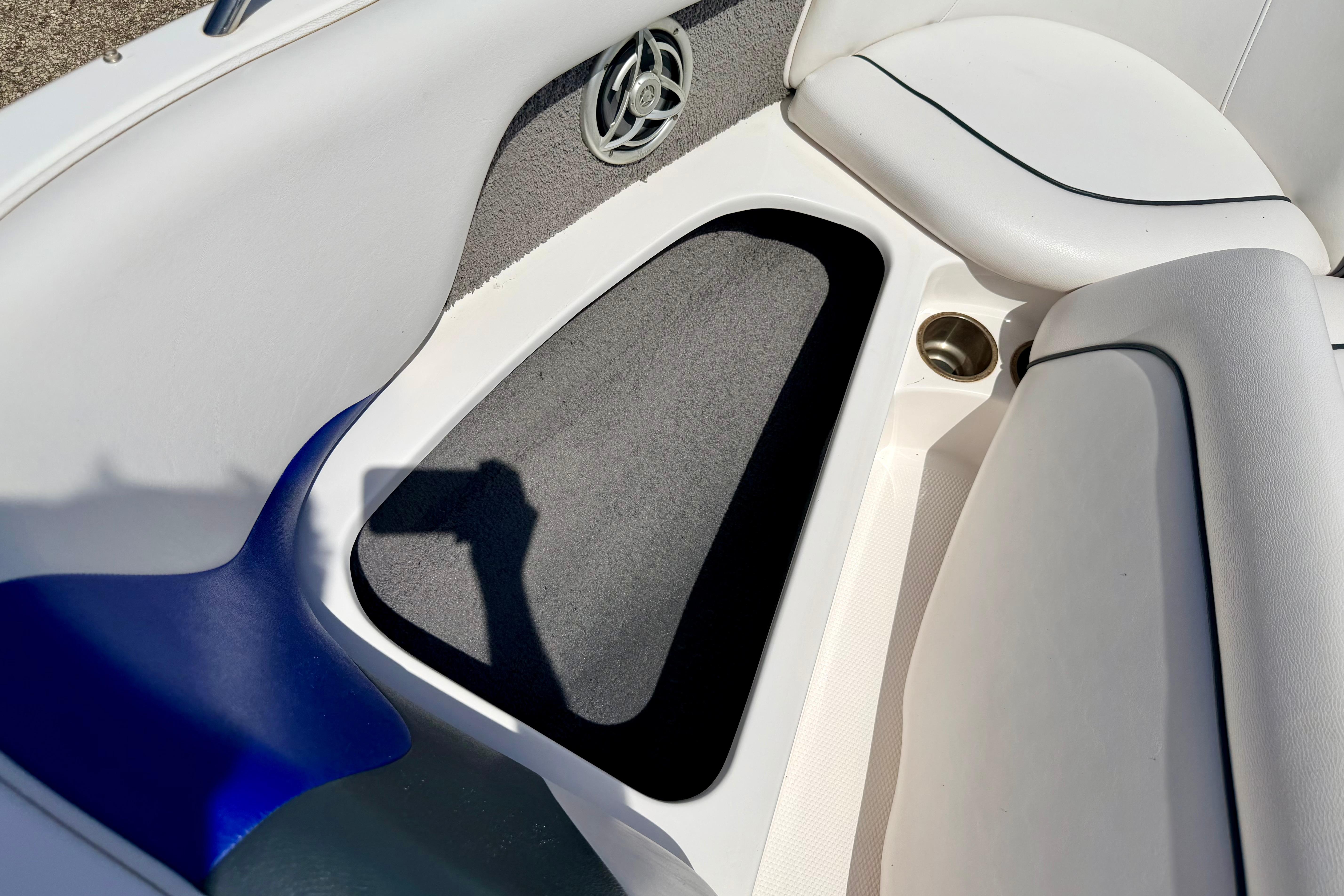 Interior of 2008 Moomba Outback V boat, featuring white seating and speaker detail.