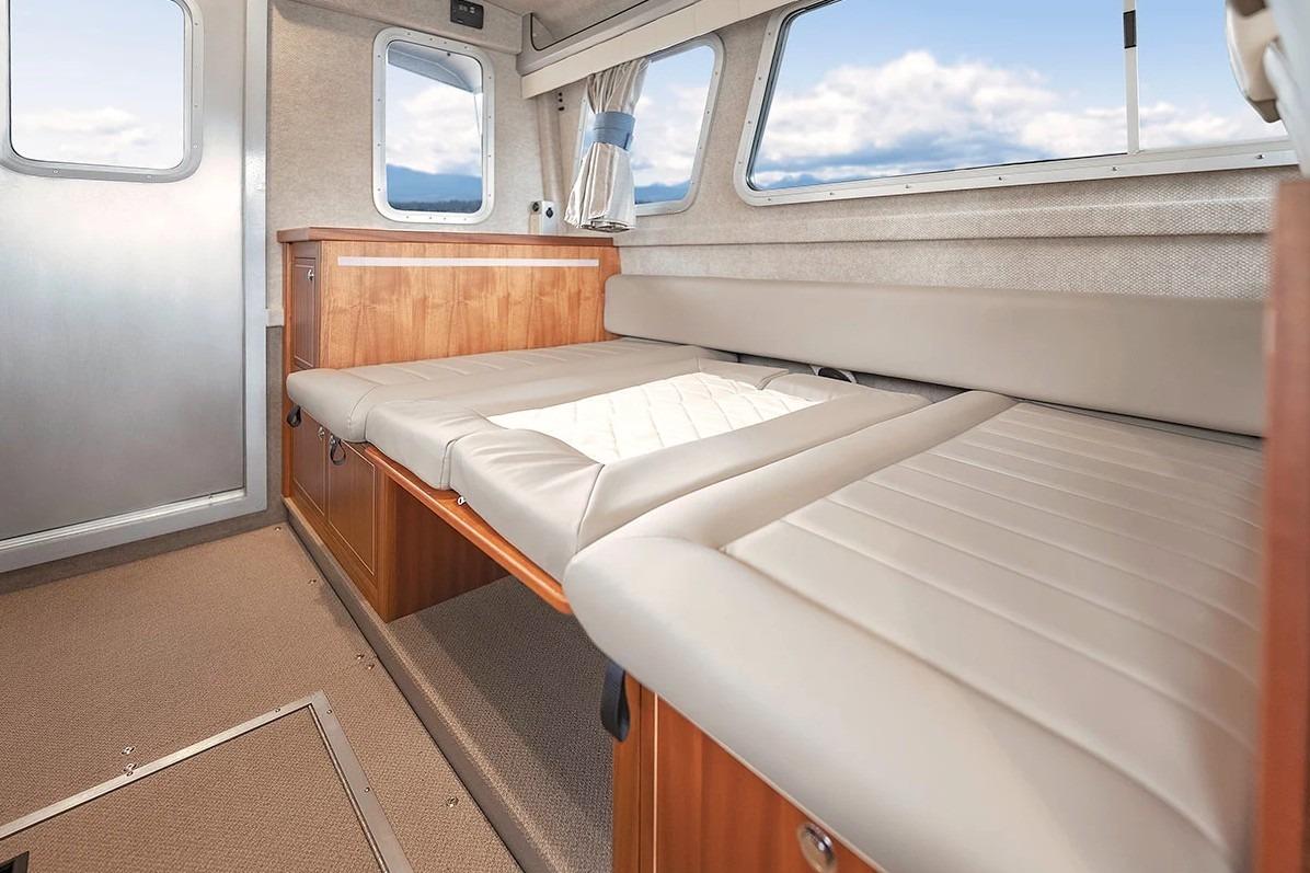 Interior of 2026 KingFisher 3225 GFX Offshore boat with comfortable seating and windows.