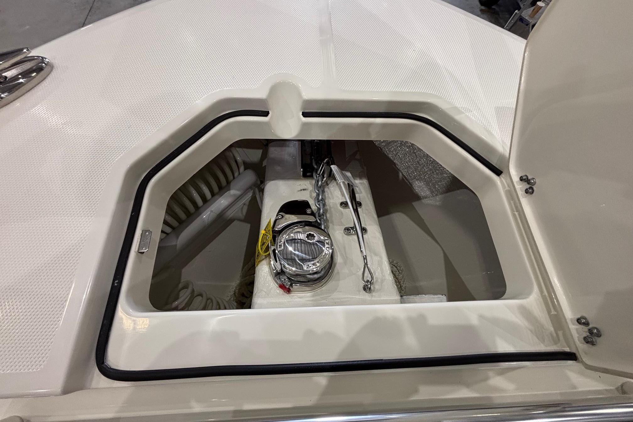 An open storage compartment on a Cobia 285 Open Center Console boat.