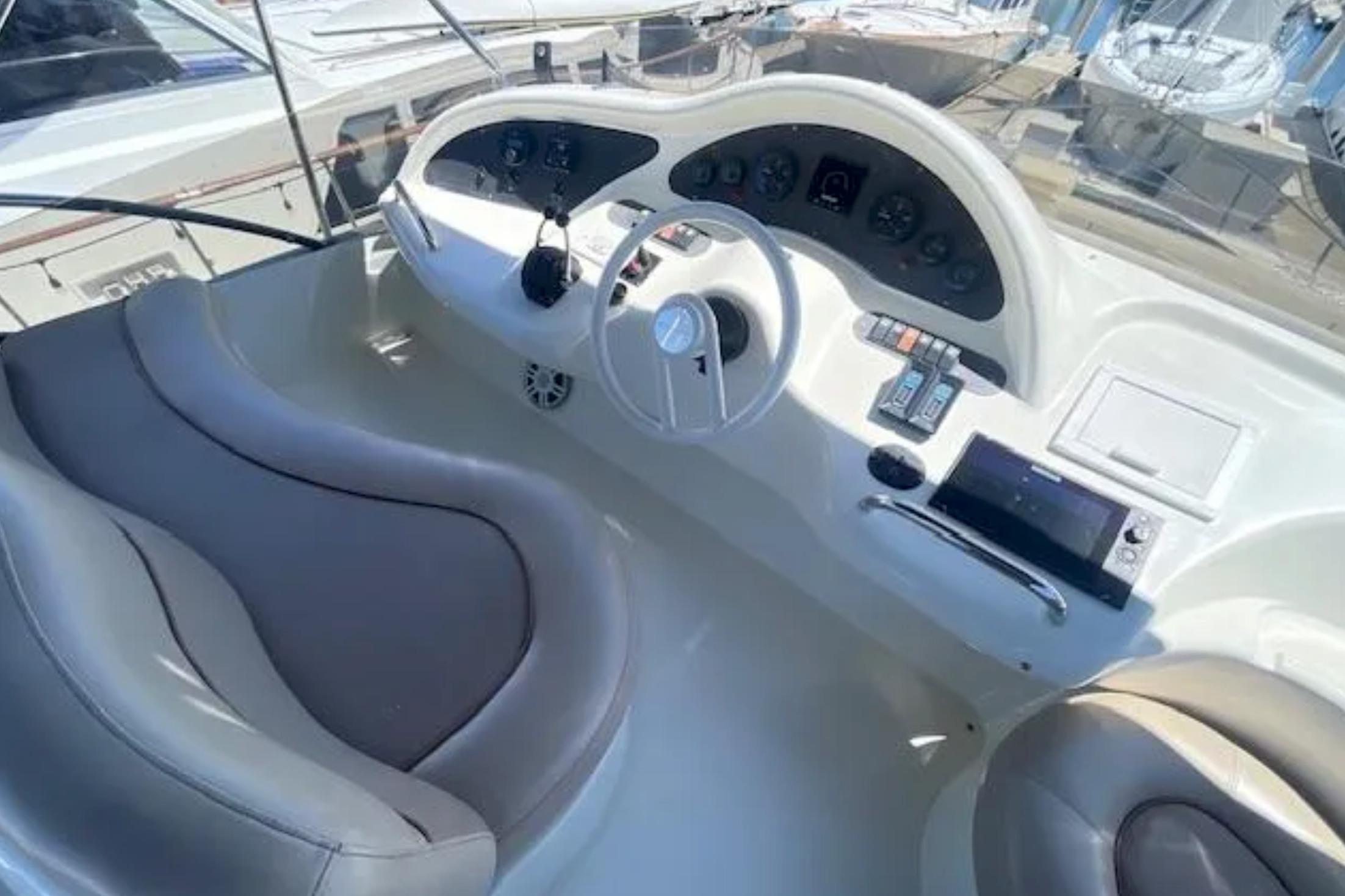 Cockpit of 2004 Azimut 46 yacht with steering wheel and control panel.
