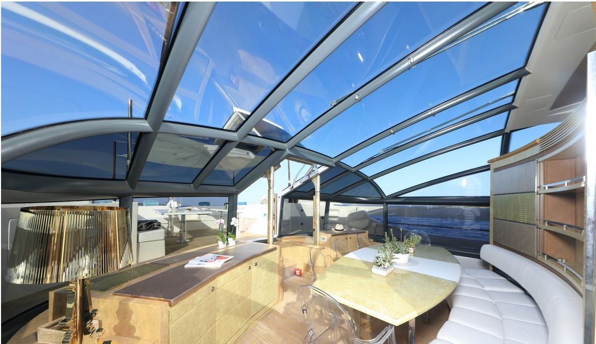 Luxurious interior of 2010 Baia ONE HUNDRED yacht with panoramic glass ceiling.