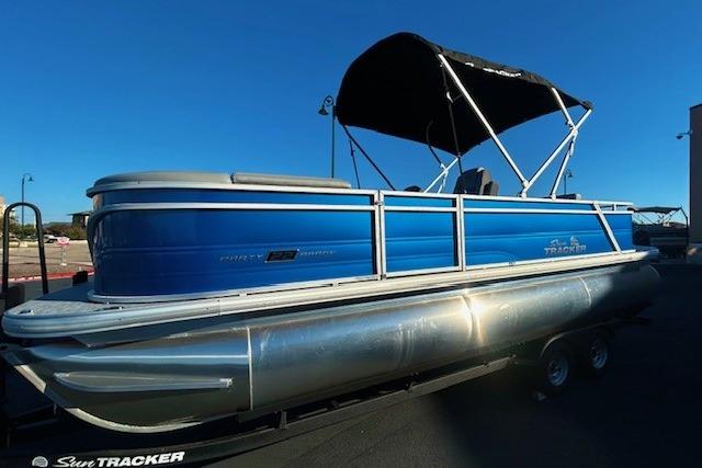 2026 Sun Tracker Party Barge 22 RF XP3 pontoon boat with blue exterior and canopy.