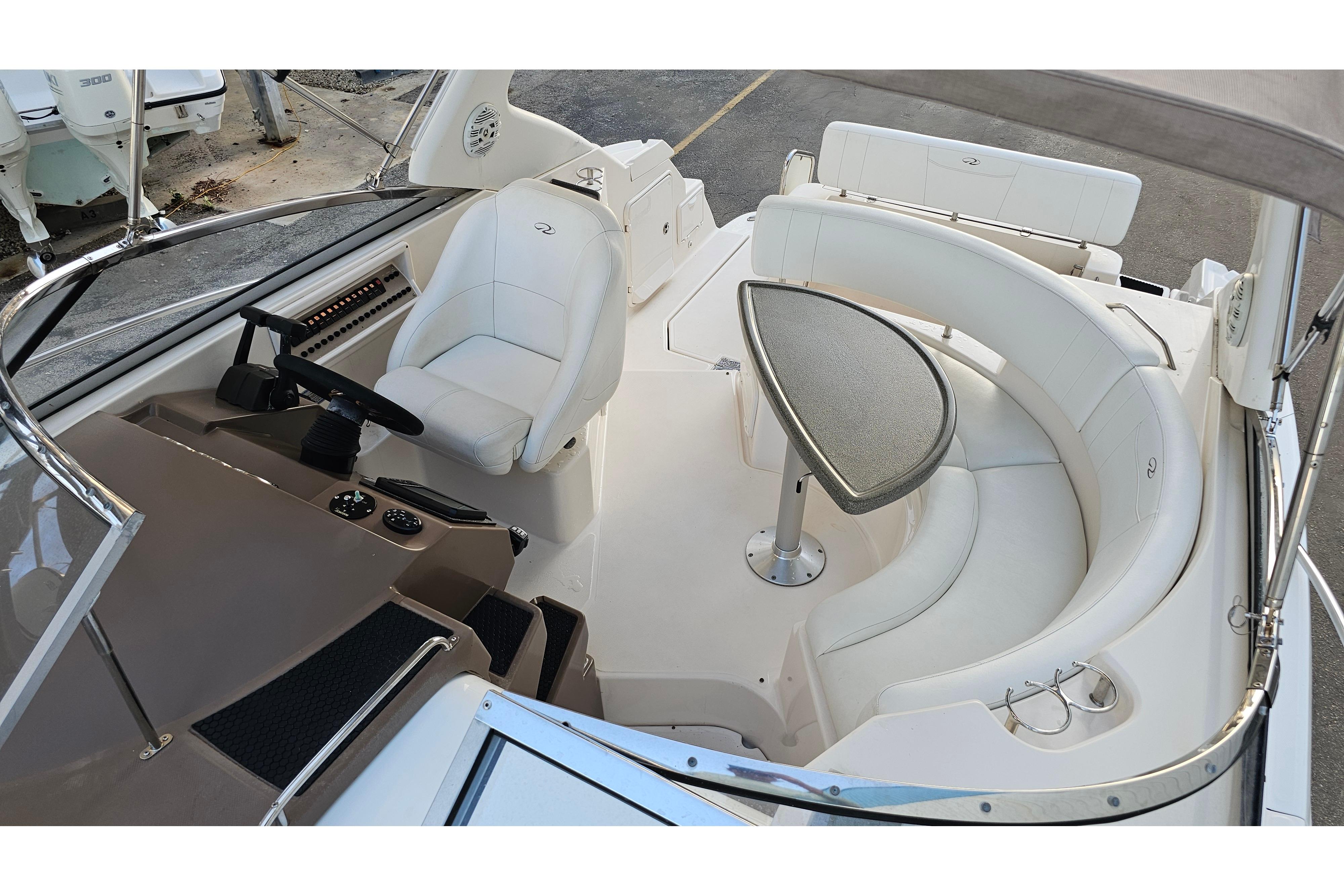 2005 Regal 3060 Window Express boat interior with helm, seating, and table.