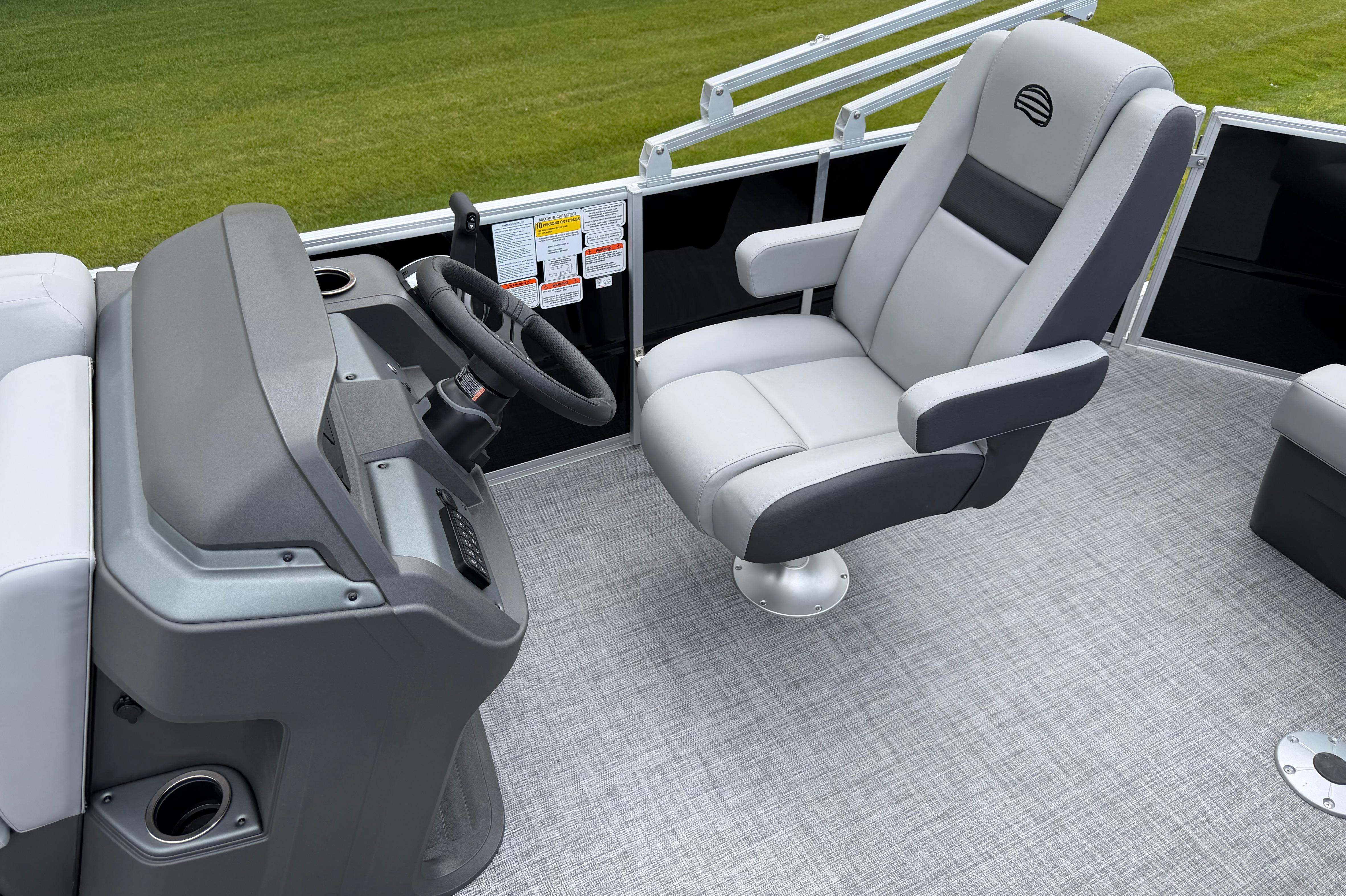 2026 Sun Tracker Party Barge 20 DLX interior with captain's chair and steering console.