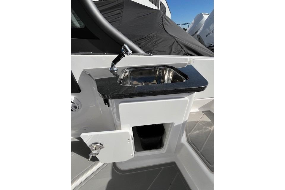 2026 Monterey Elite 27 SD boat sink with storage compartment and sleek design.