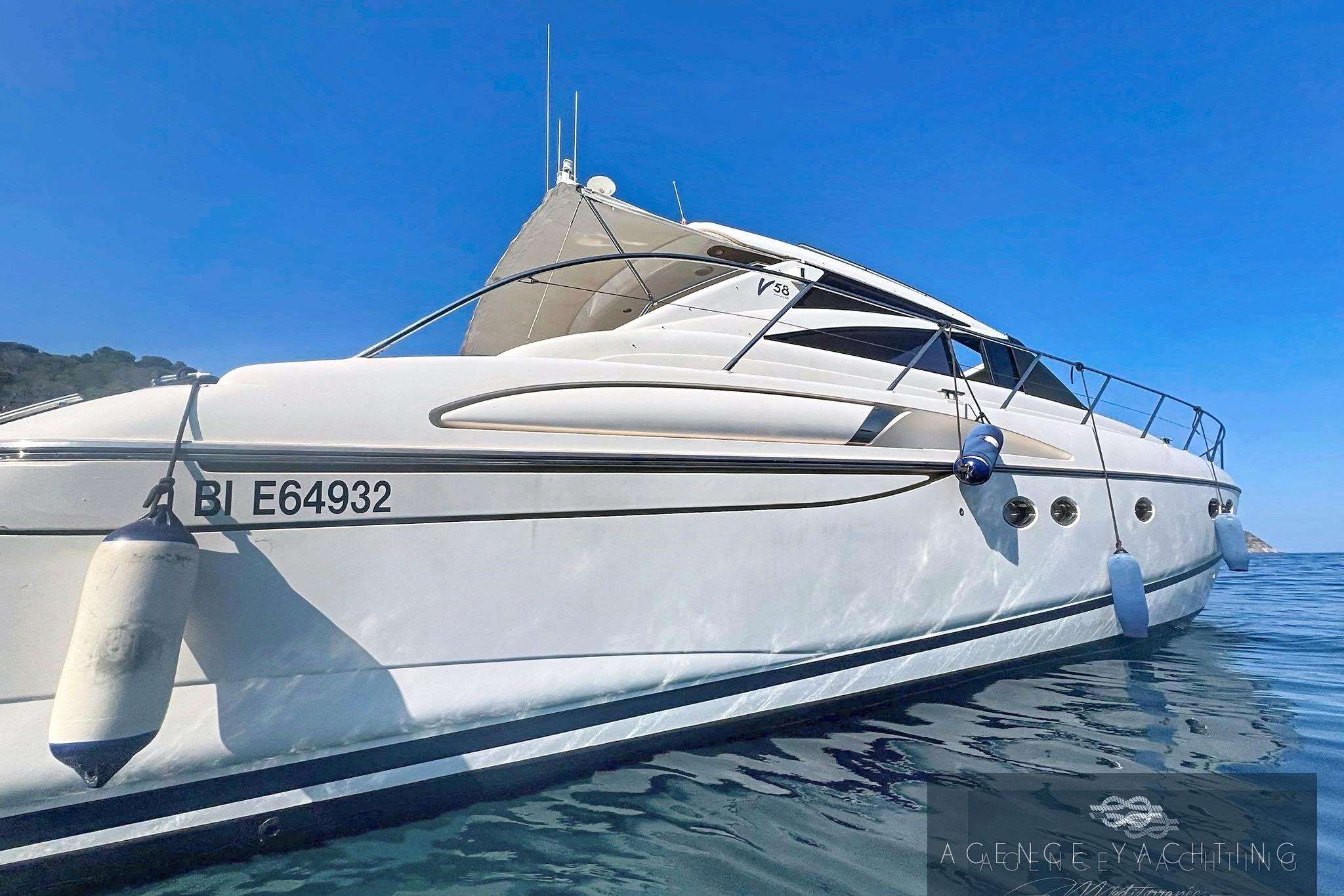 2004 Princess V58 yacht on calm blue waters, side view.