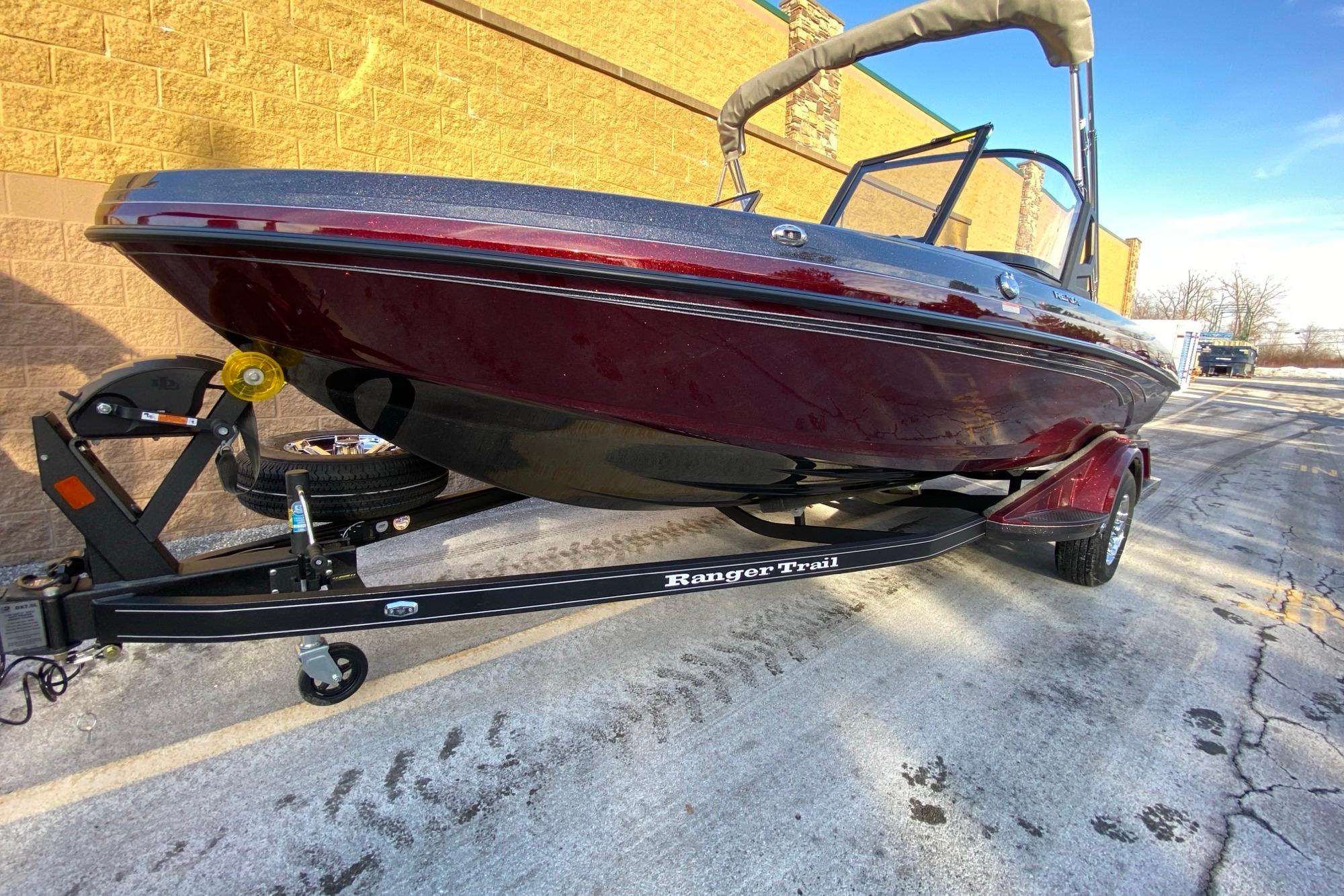 2026 Ranger 1850MS boat on trailer, parked outdoors, showcasing sleek design and maroon color.