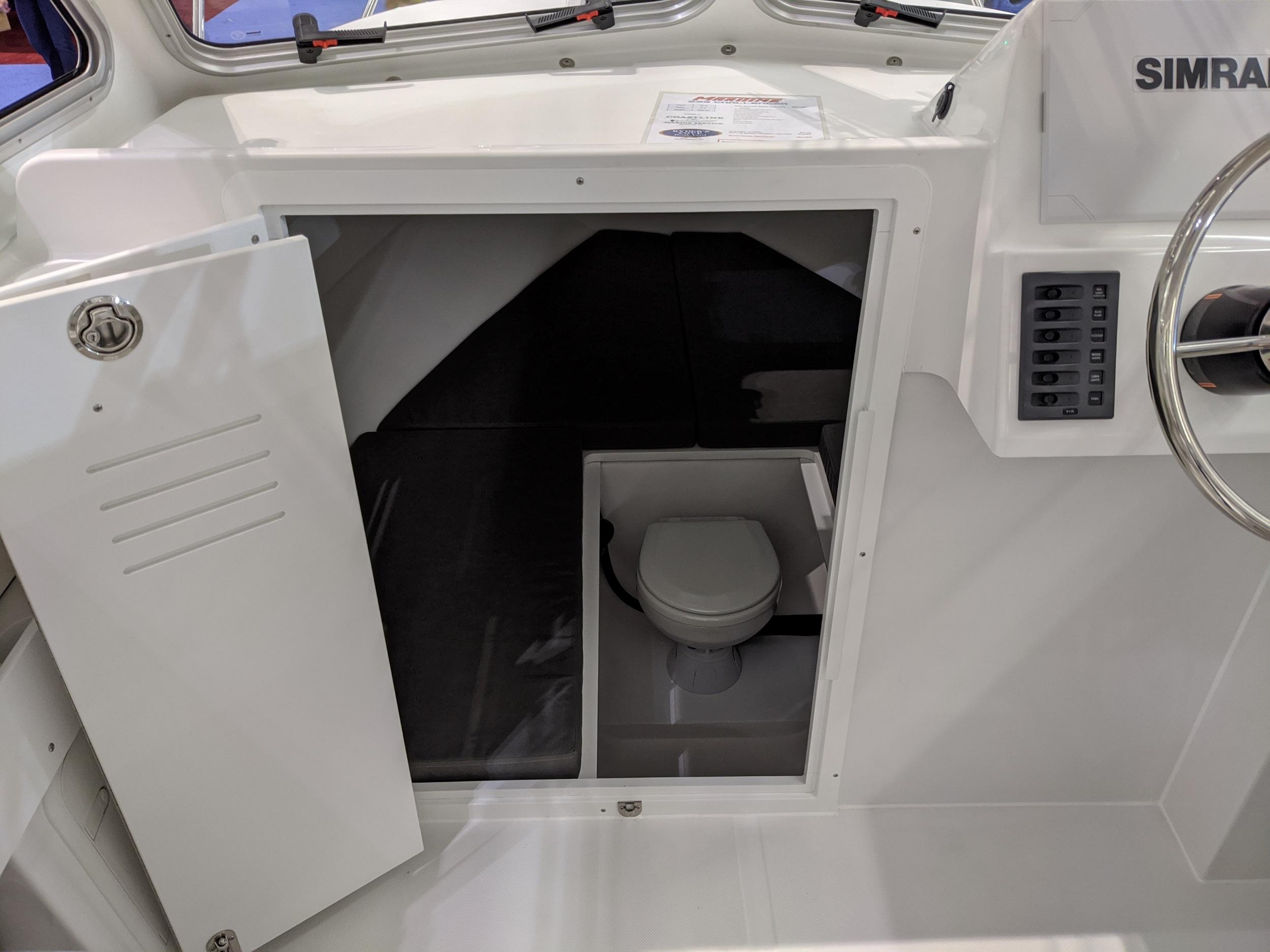 2020 Maritime 23 Challenger boat interior with compact cabin toilet.