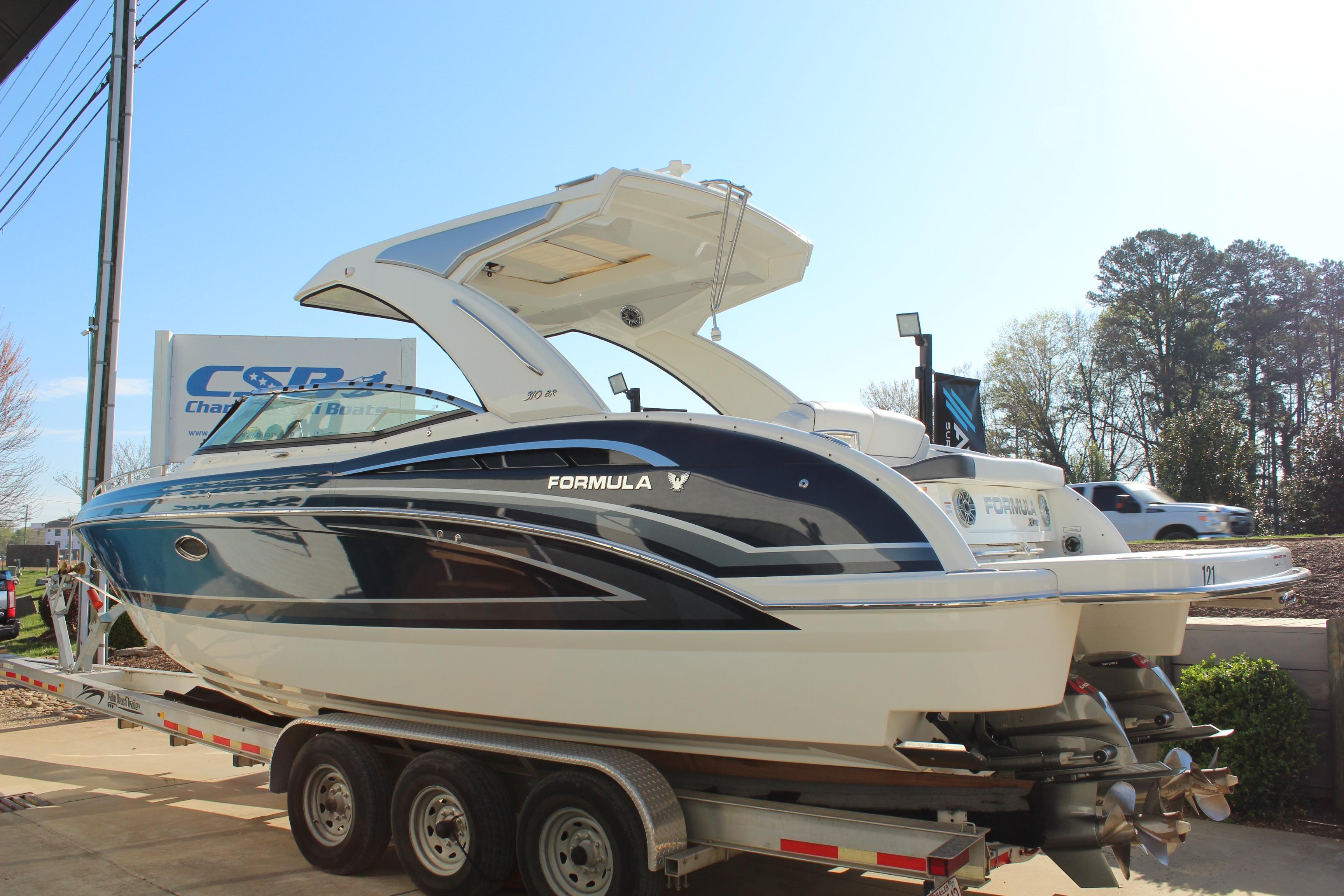 2023 Formula 310 Bowrider I/O boat on trailer, displayed outdoors.