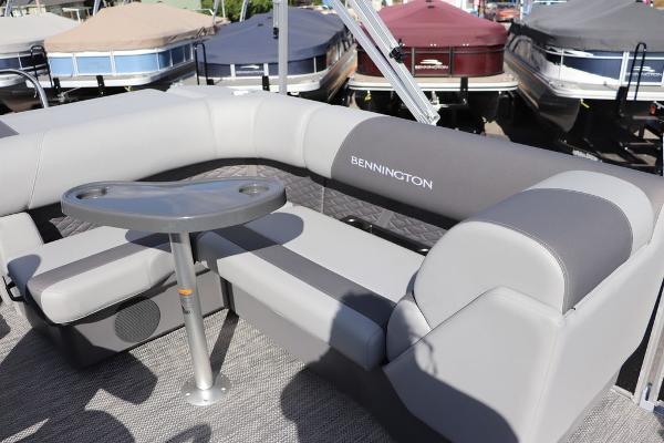 2024 Bennington 20 SL pontoon boat with gray seating and table.