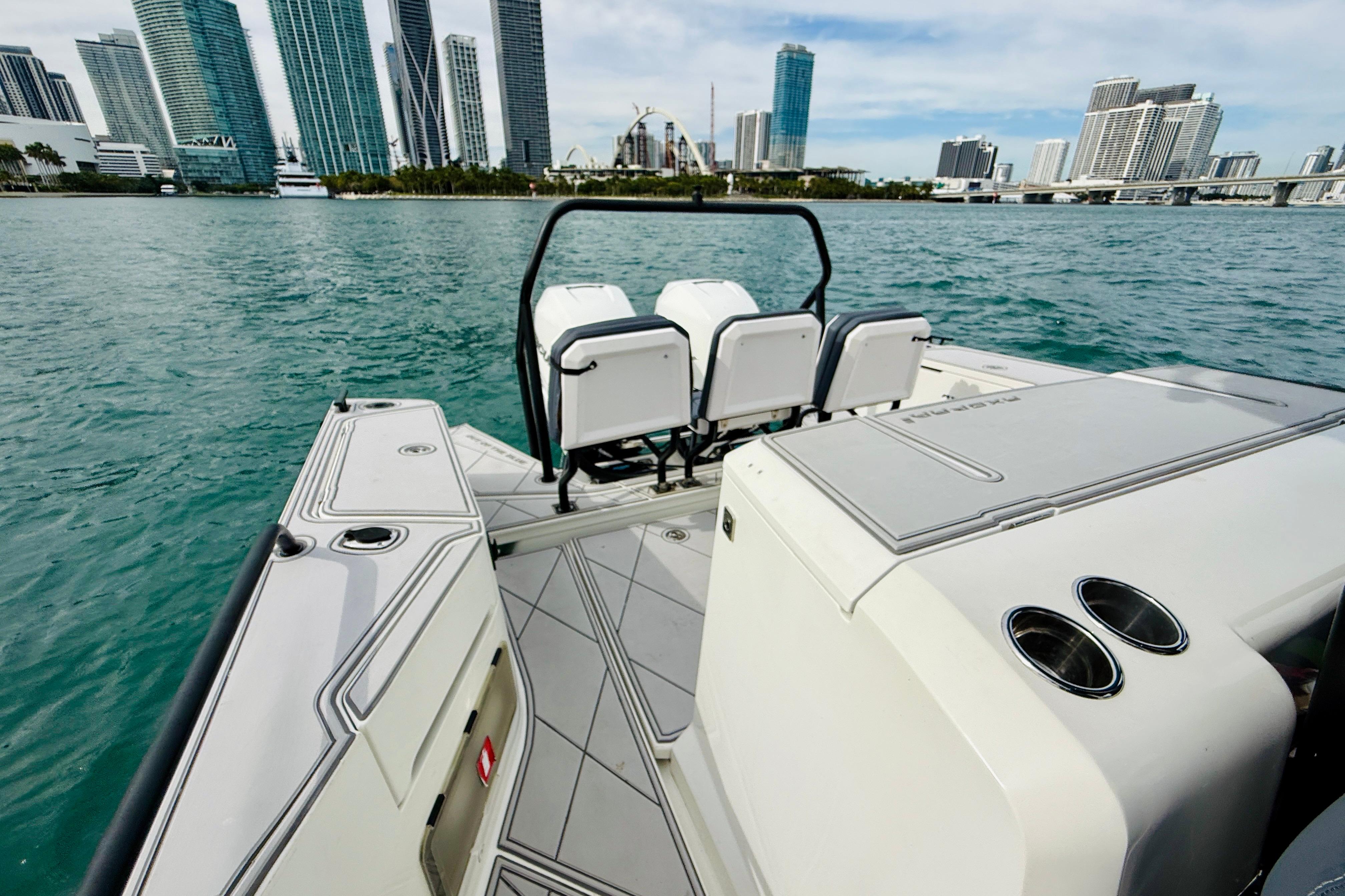 2021 Axopar 37 Sun Top boat with city skyline in the background.