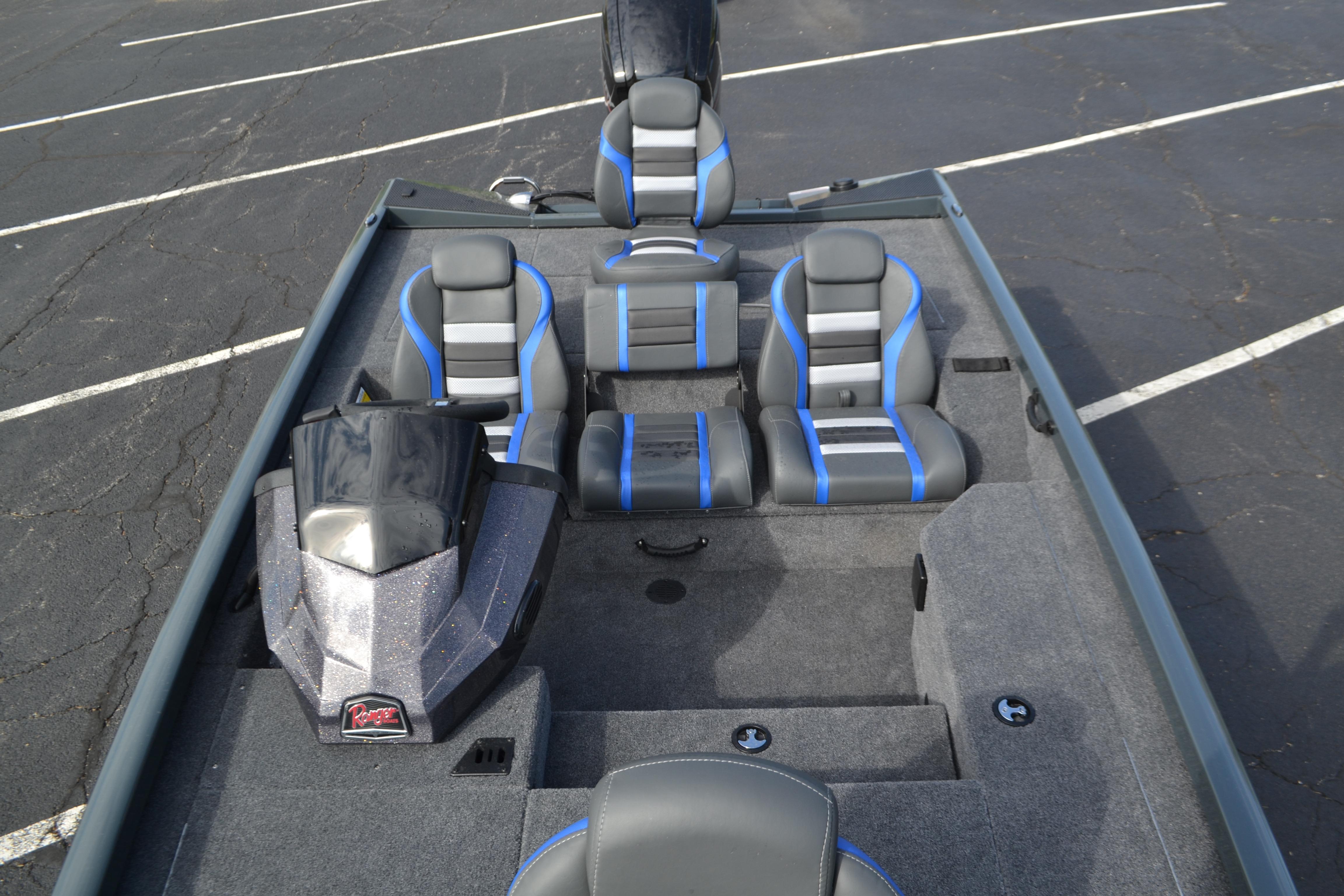 2026 Ranger RT178 boat interior with gray and blue seating, parked on asphalt.