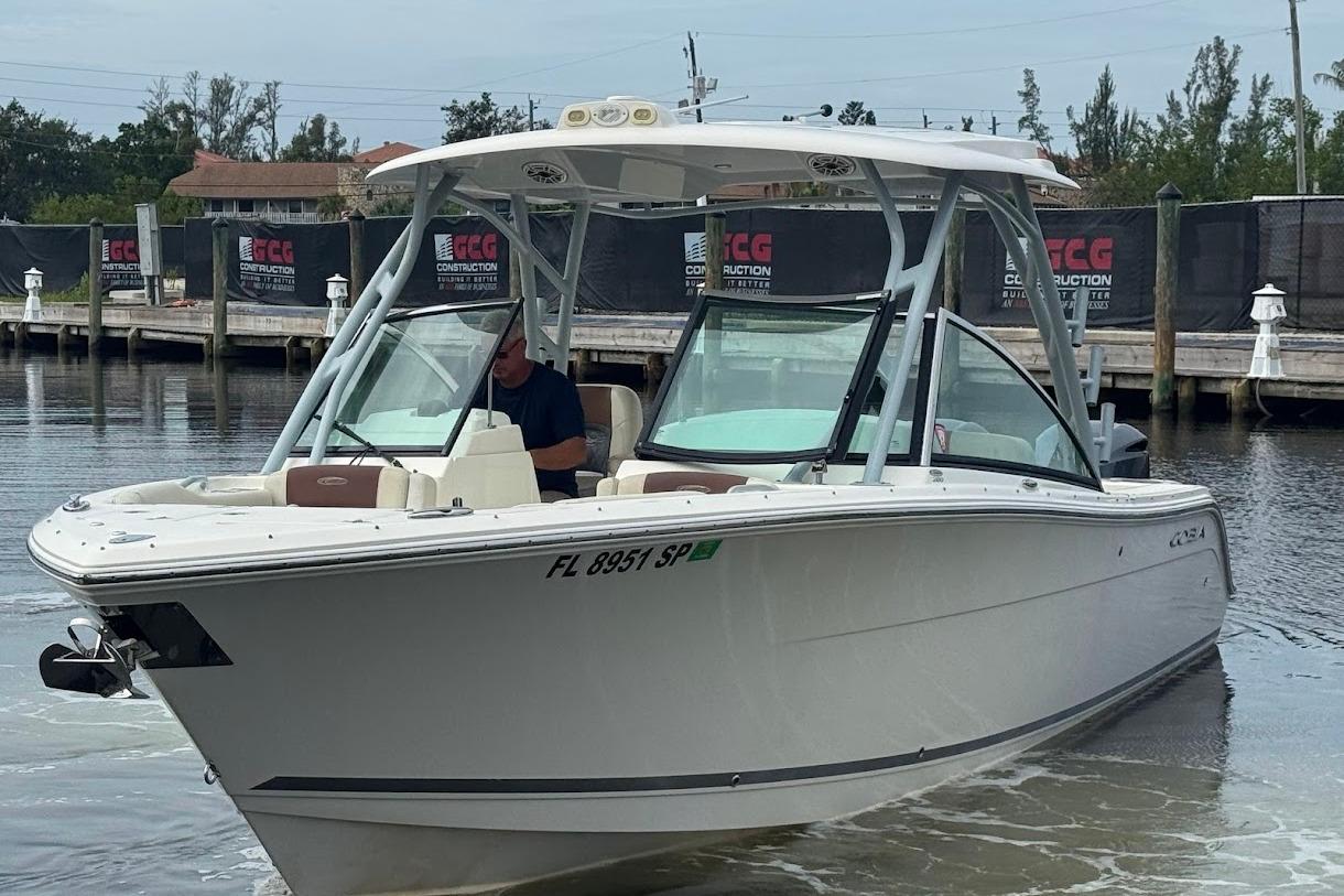 2020 Cobia 280 Dual Console boat docked in a marina setting.