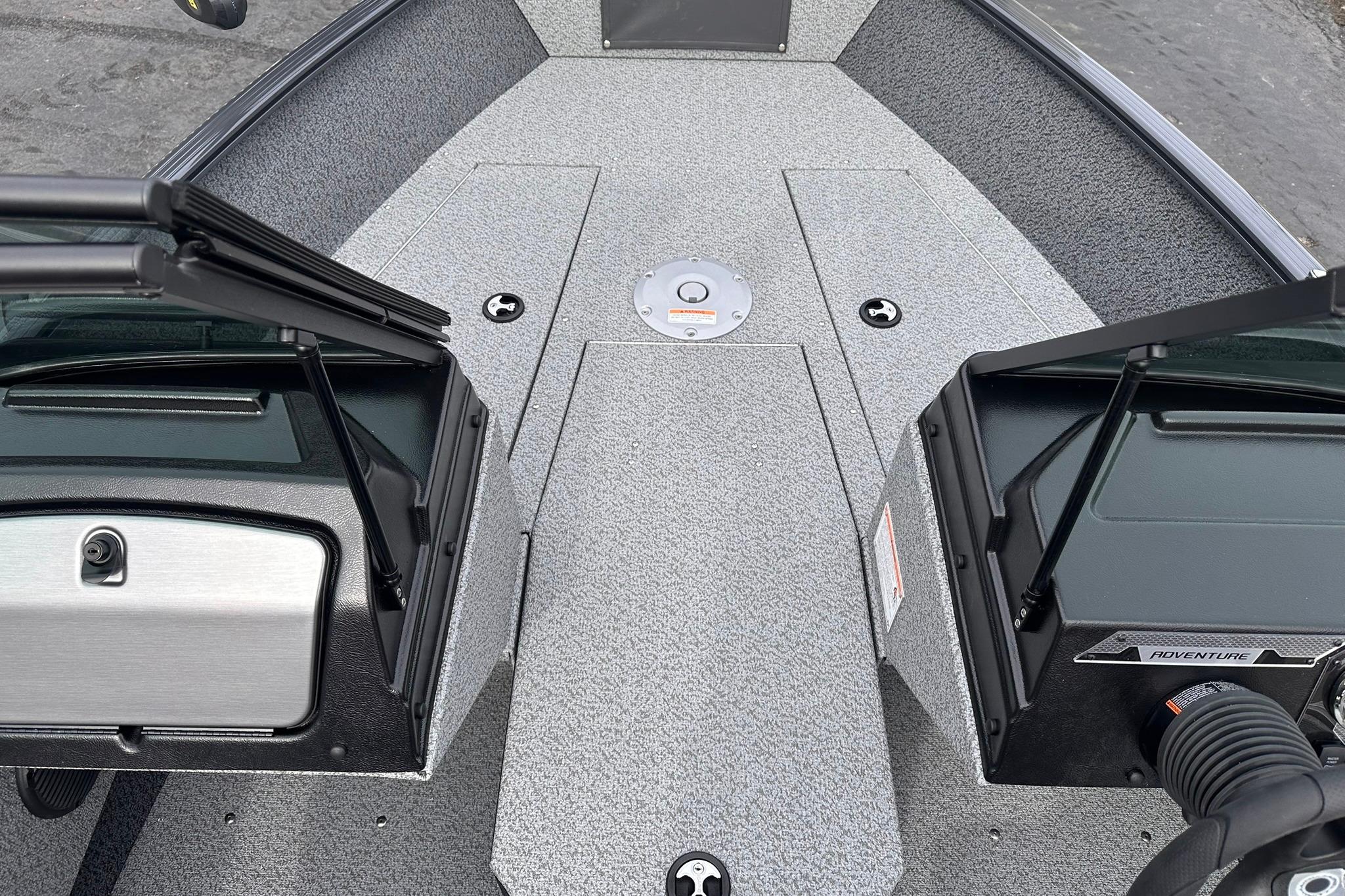 2026 Lund 1775 Adventure Sport boat interior with open compartments and textured flooring.