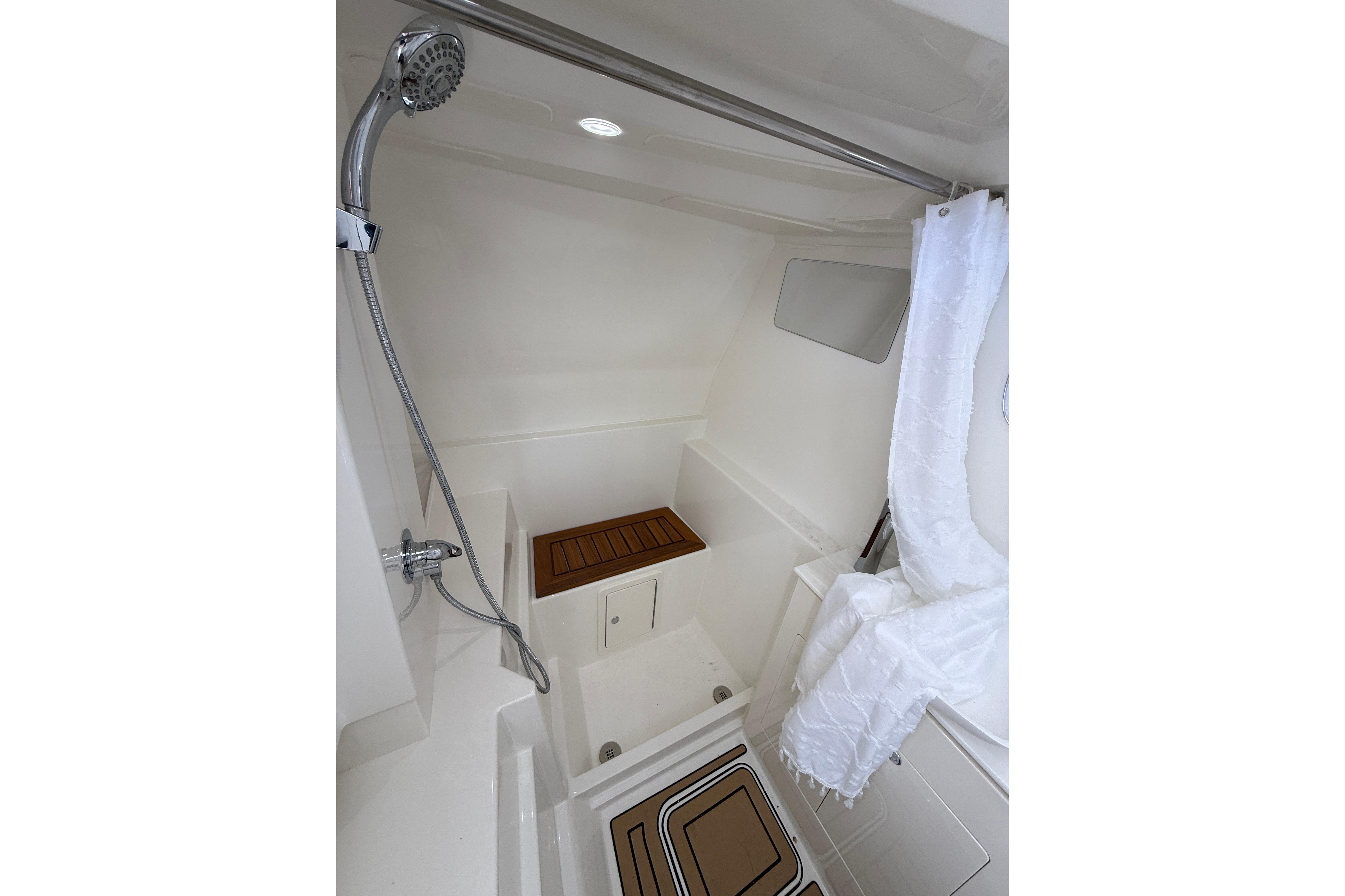 Modern shower area in 2026 World Cat 400 DC-X Island boat, featuring sleek design and wooden accents.