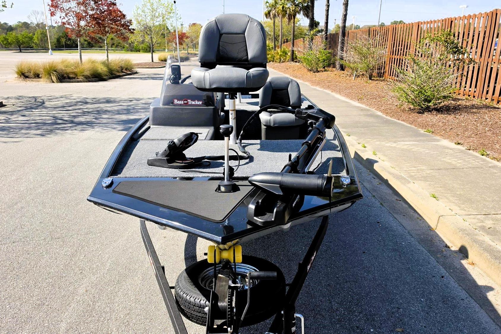 2026 Tracker Bass Tracker Classic XL boat parked on pavement, featuring sleek design and comfortable seating.