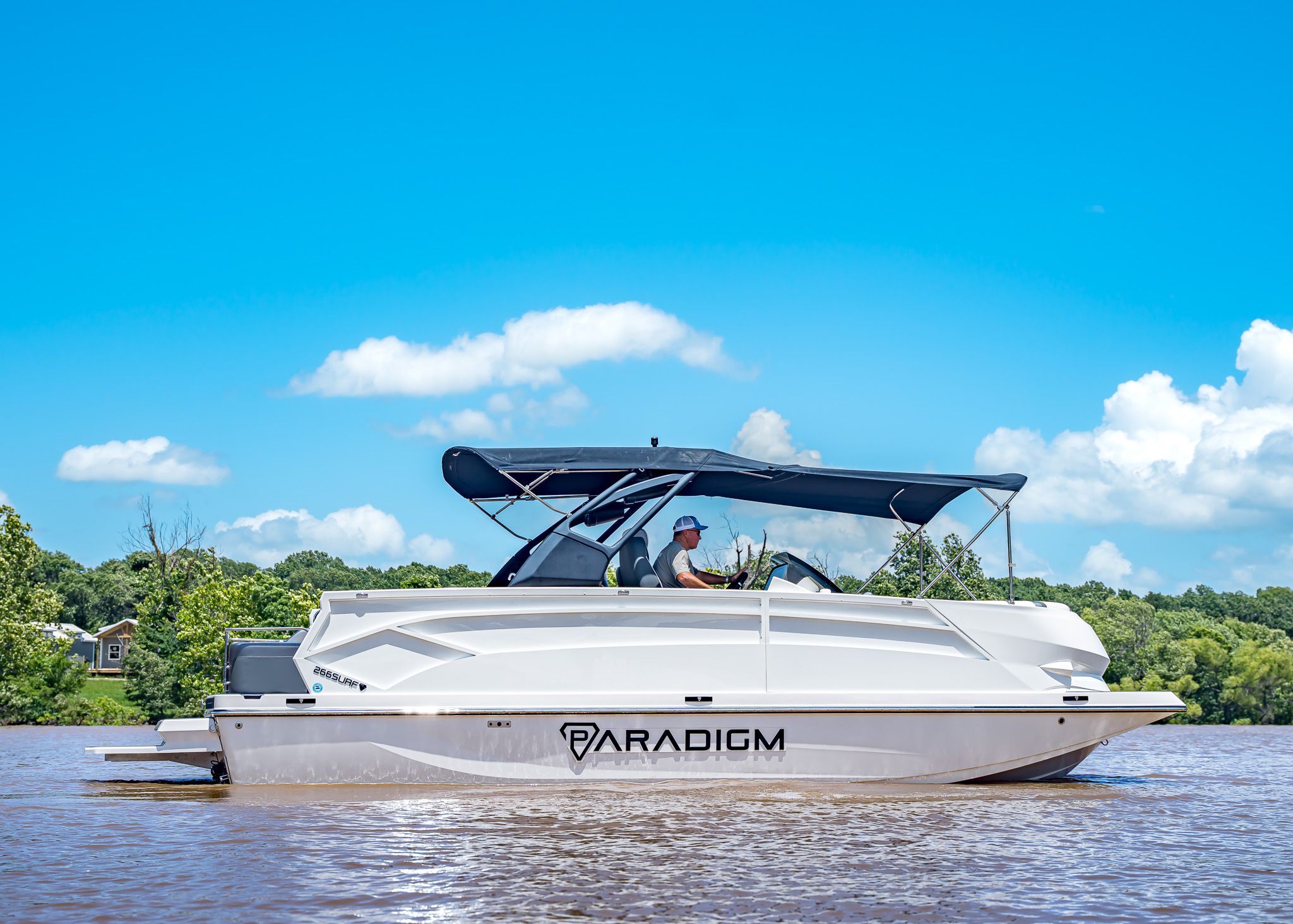 2025 Paradigm 266 SL SURF boat on calm water.
