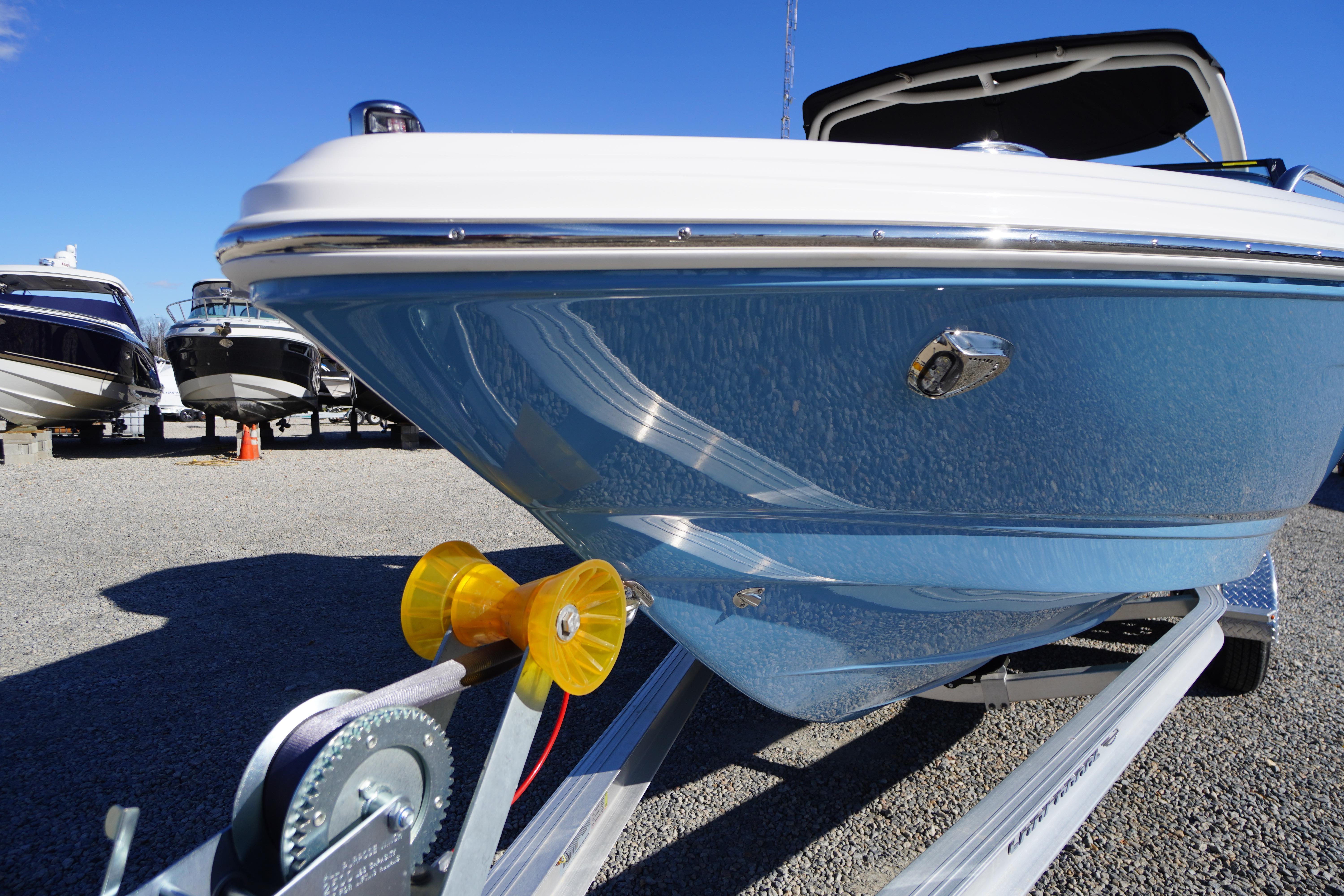 2026 Chaparral 23 SSi boat on trailer, blue hull, sunny day, outdoor display.