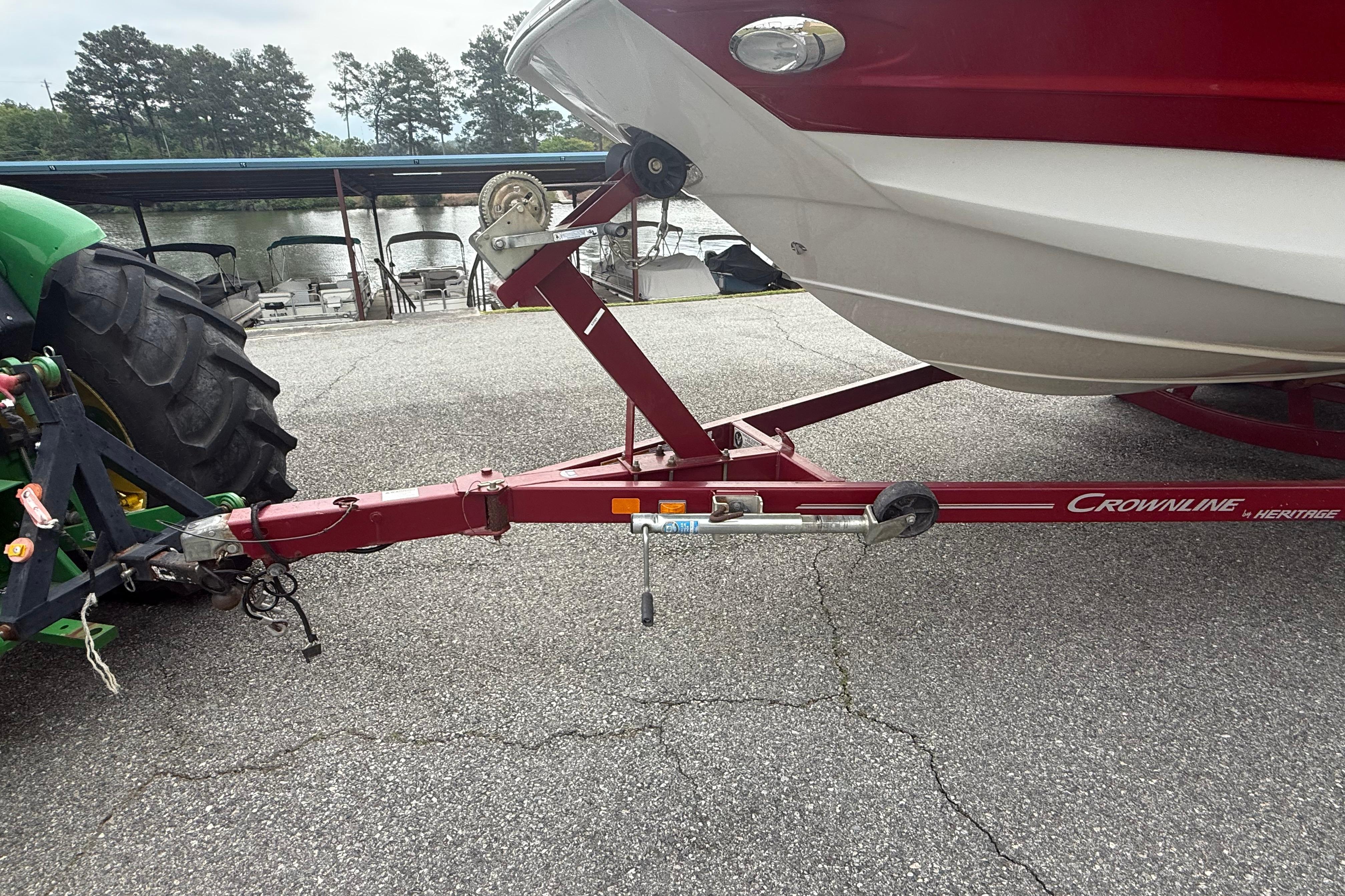 Trailer hitch of 2017 Crownline Eclipse E1 XS boat, parked near a lake.