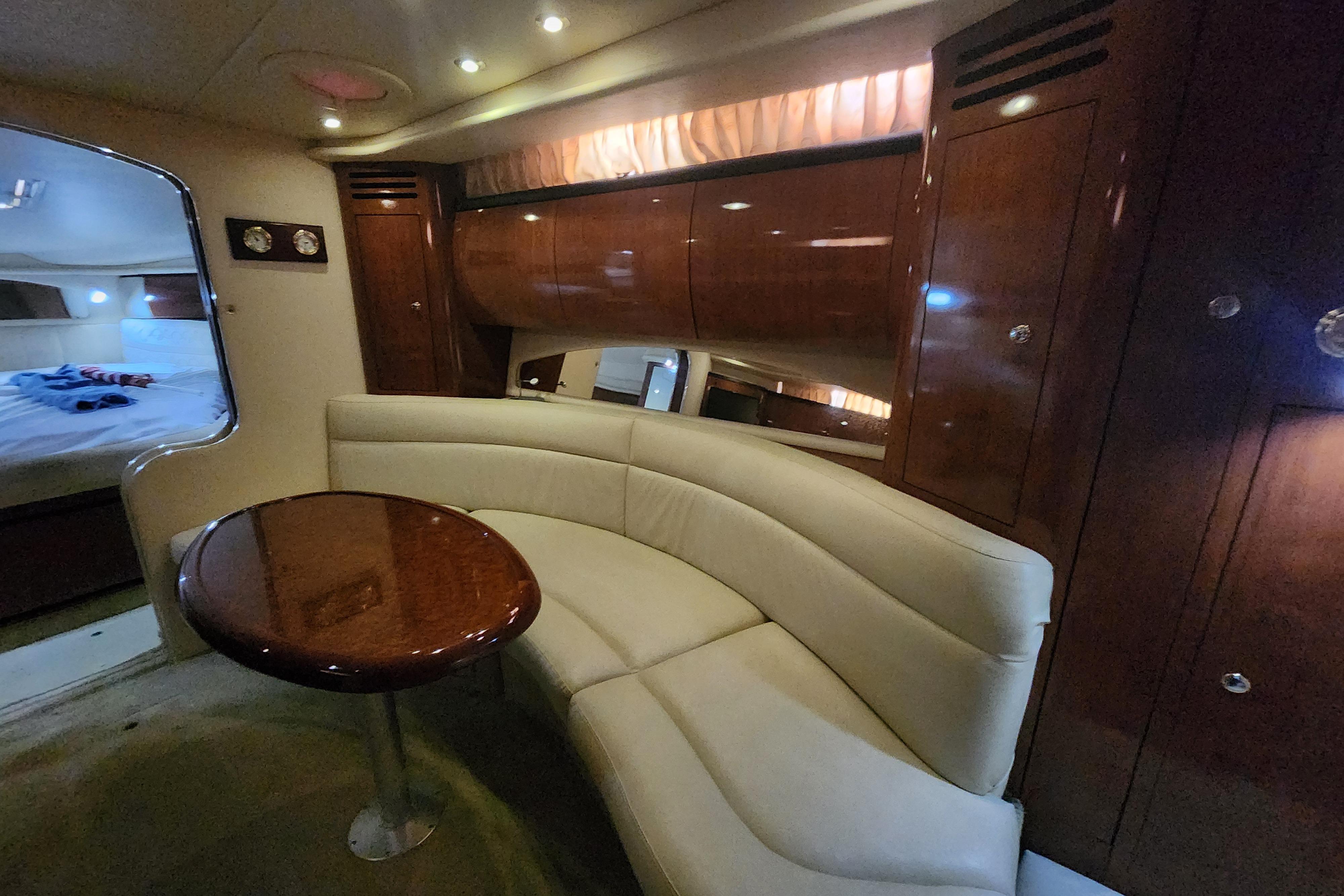 Luxurious interior of 2003 Sea Ray 360 Sundancer yacht with elegant seating and wood finishes.
