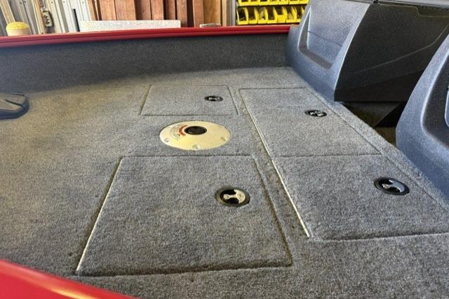 2026 Tracker Pro Guide V-16 WT boat interior with carpeted storage compartments.