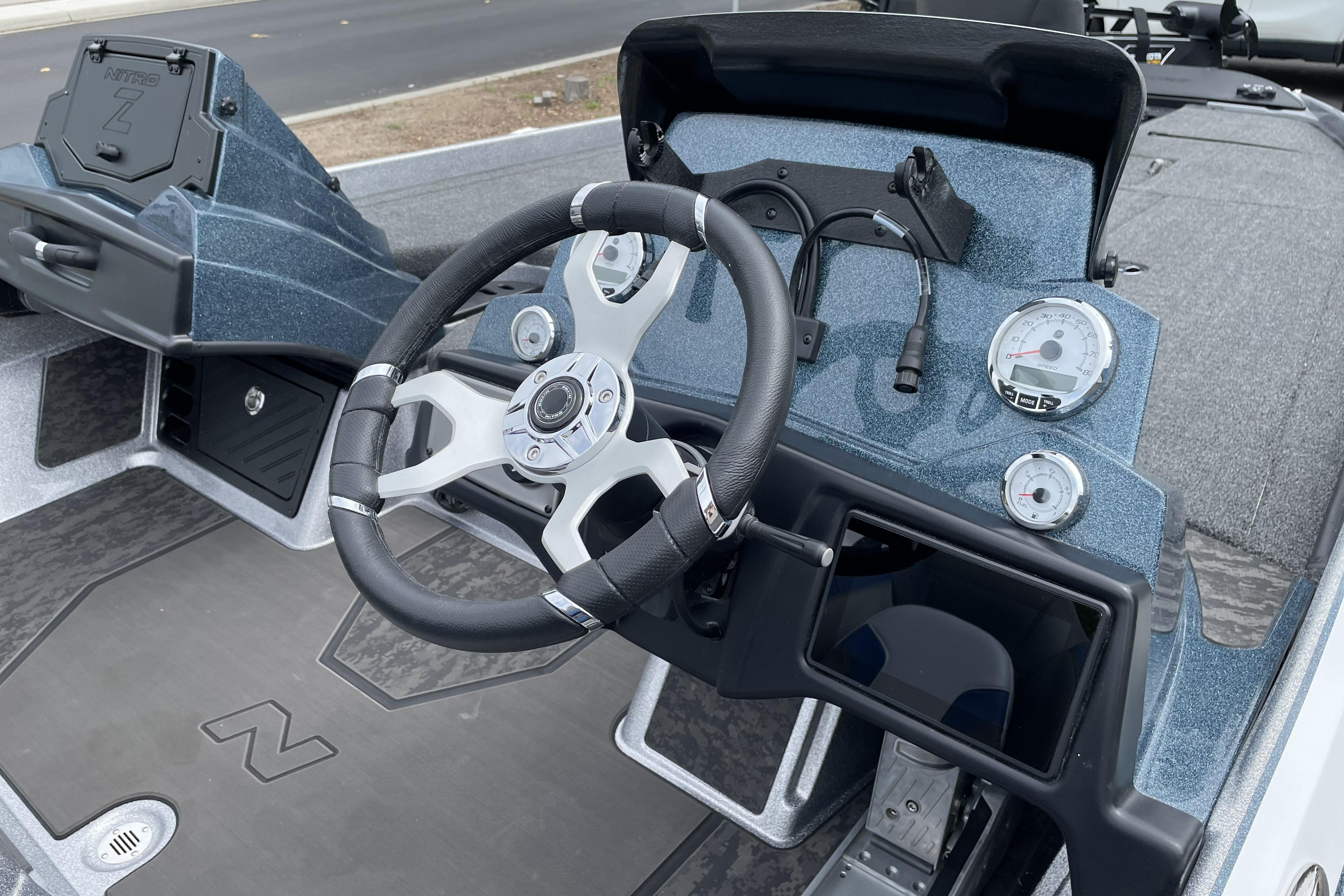2026 Nitro Z21 XL boat dashboard with steering wheel and gauges.