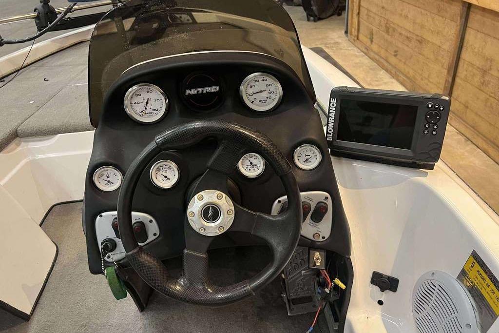 Dashboard of a 2005 Nitro NX 750 boat with steering wheel and Lowrance display.