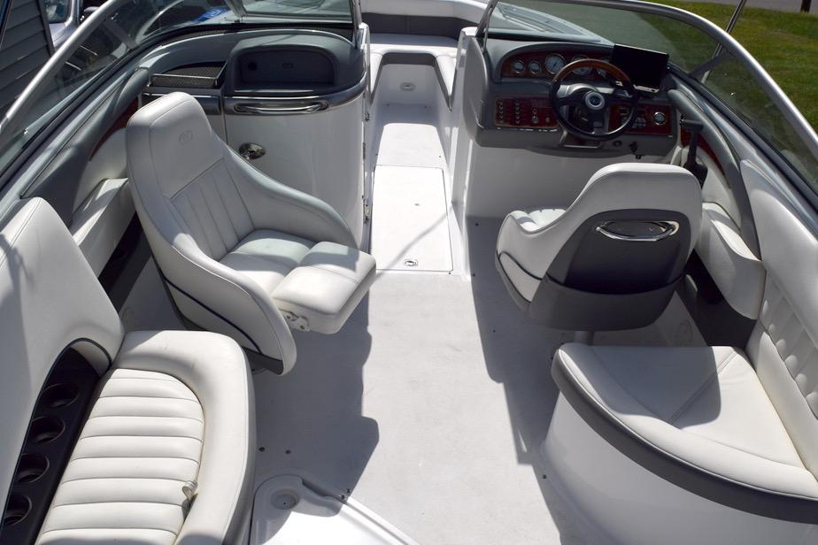 2006 Cobalt 240 boat interior with white seating and sleek dashboard design.