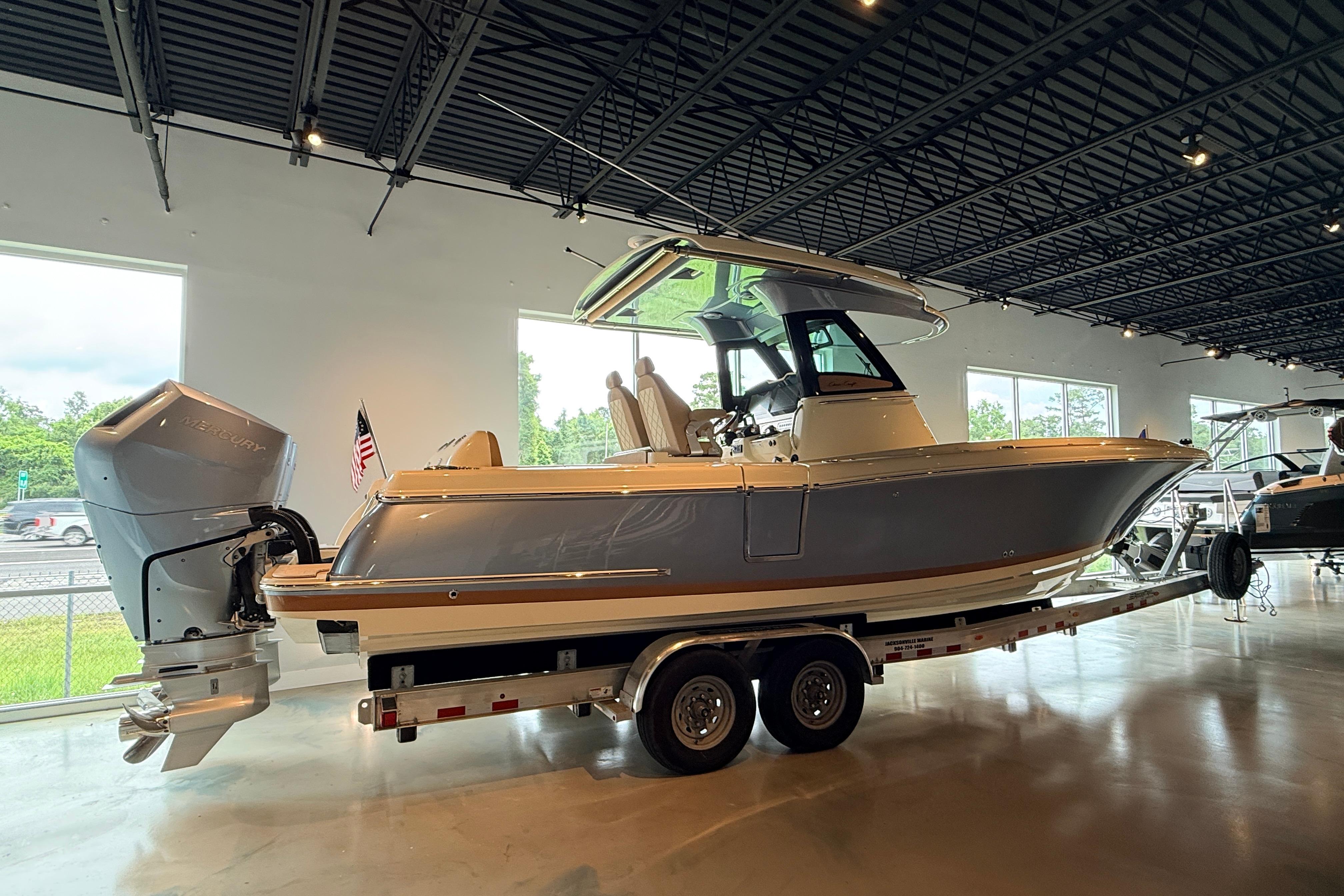 2024 Chris-Craft Catalina 30 boat displayed indoors on a trailer.