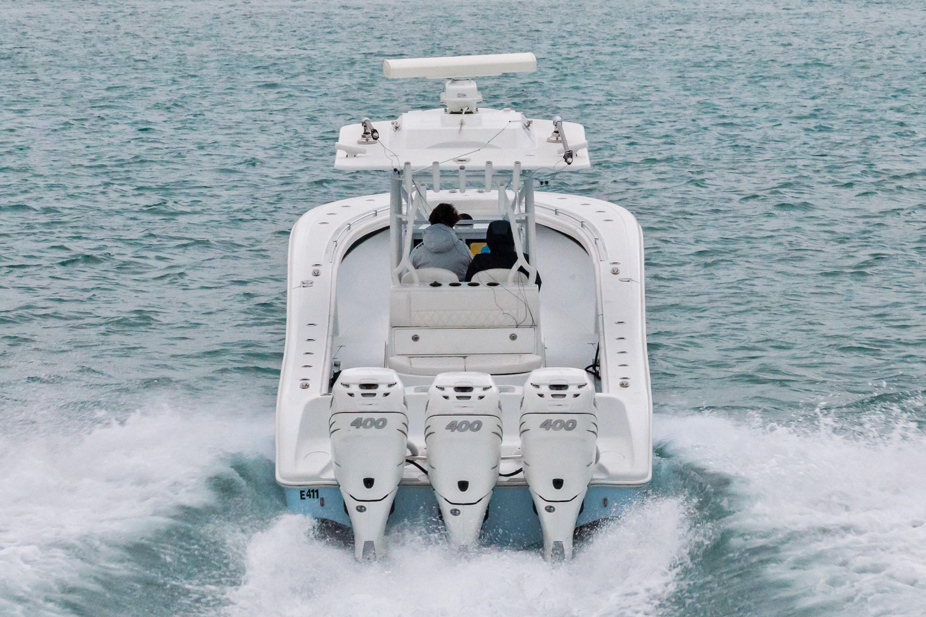 2021 Yellowfin 36 Offshore boat cruising on open water, rear view.