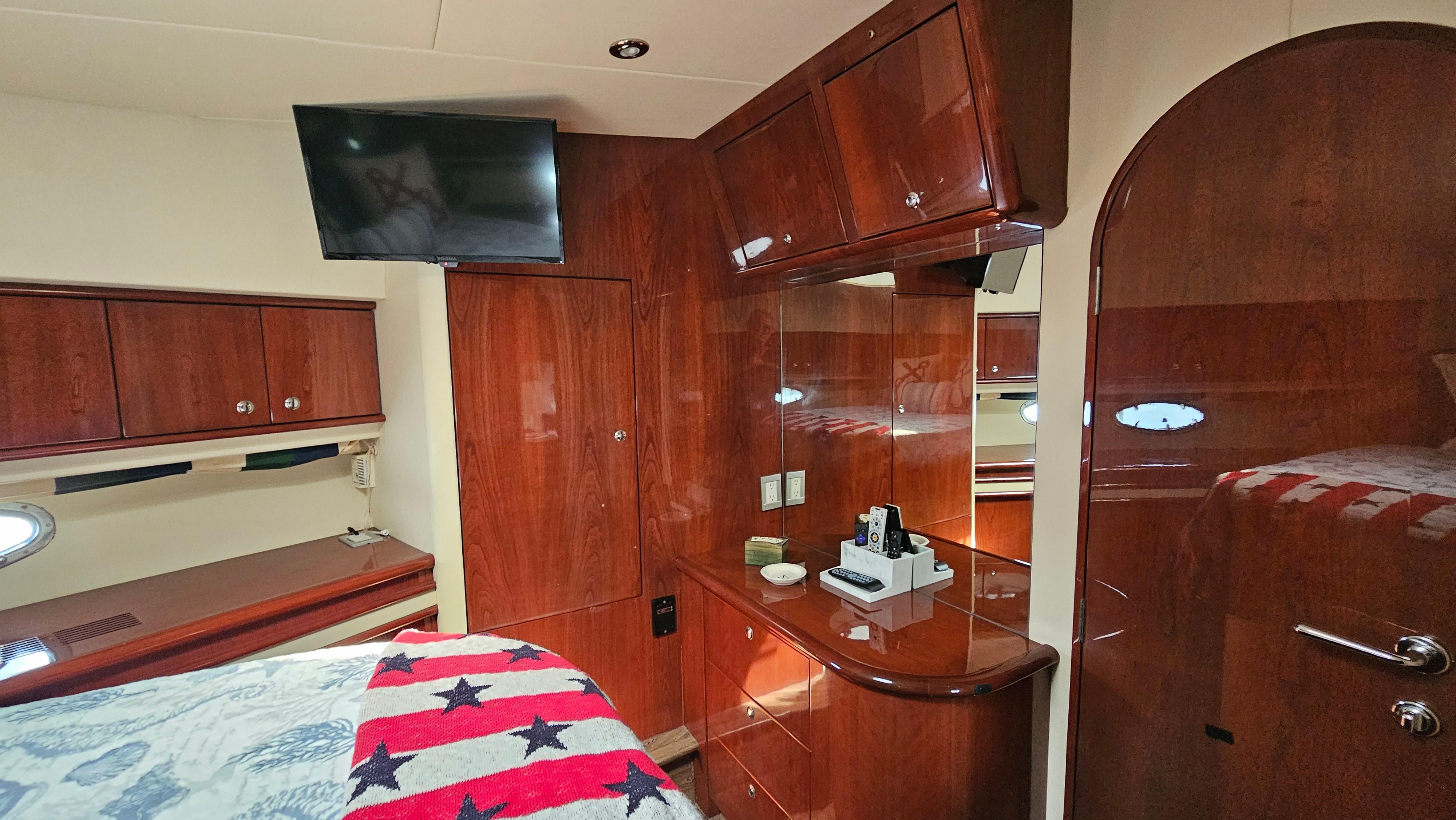 Luxurious 2005 Neptunus 56 Flybridge yacht interior with wood cabinetry and modern amenities.