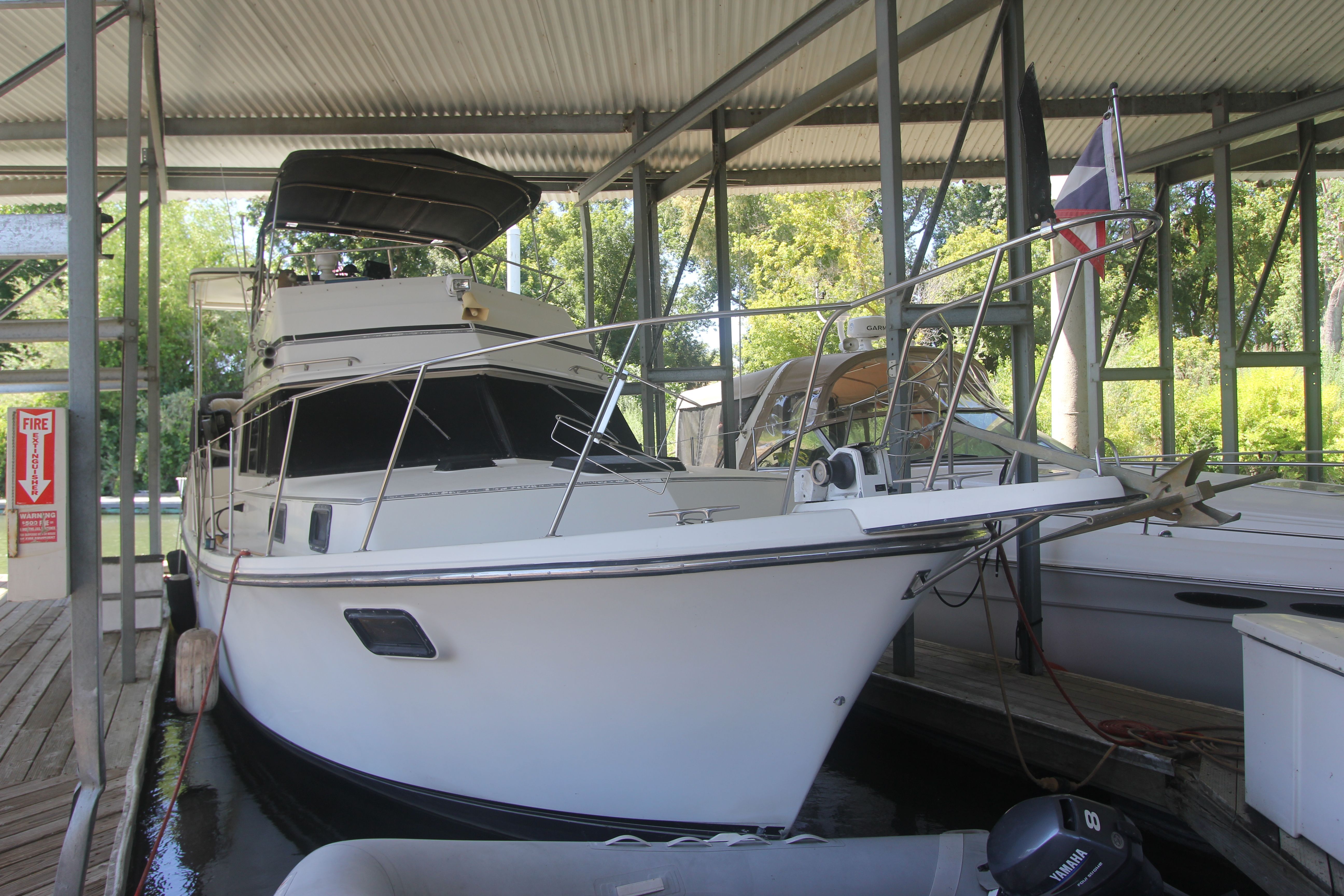 A 1988 Carver 3607 Aft Cabin Motor Yacht docked in a covered marina.