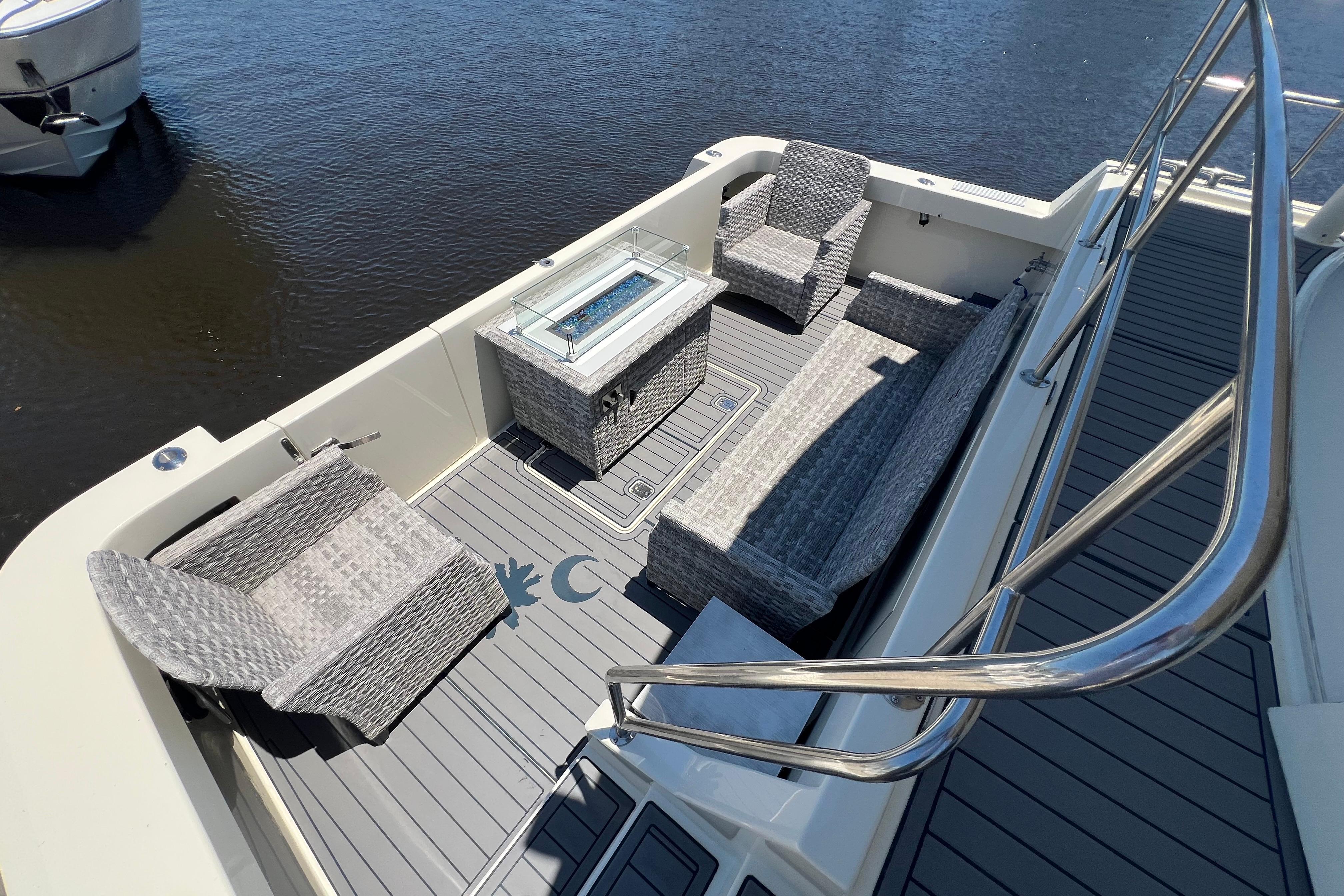 Outdoor seating area on 1987 Hatteras 70 Cockpit Motor Yacht with wicker furniture.