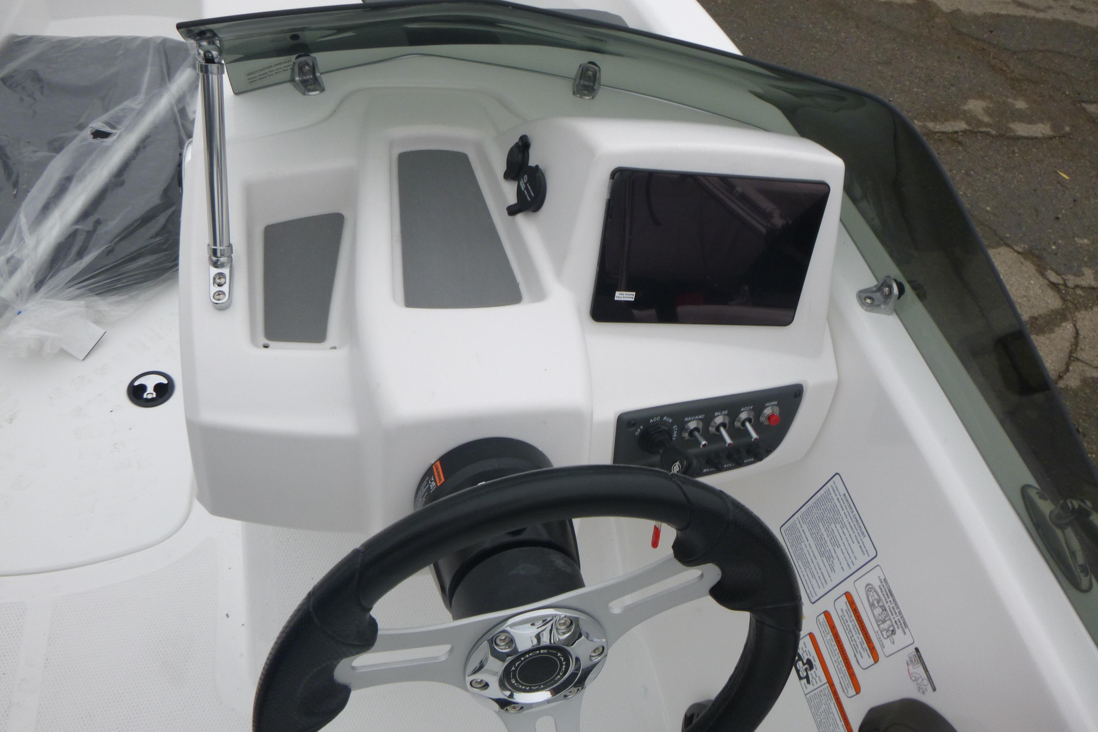 2026 Tahoe T16 boat dashboard with steering wheel and control panel.