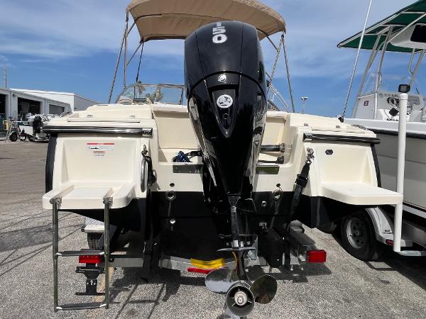 2021 Scout 210 Dorado boat with powerful outboard motor, parked on a trailer.