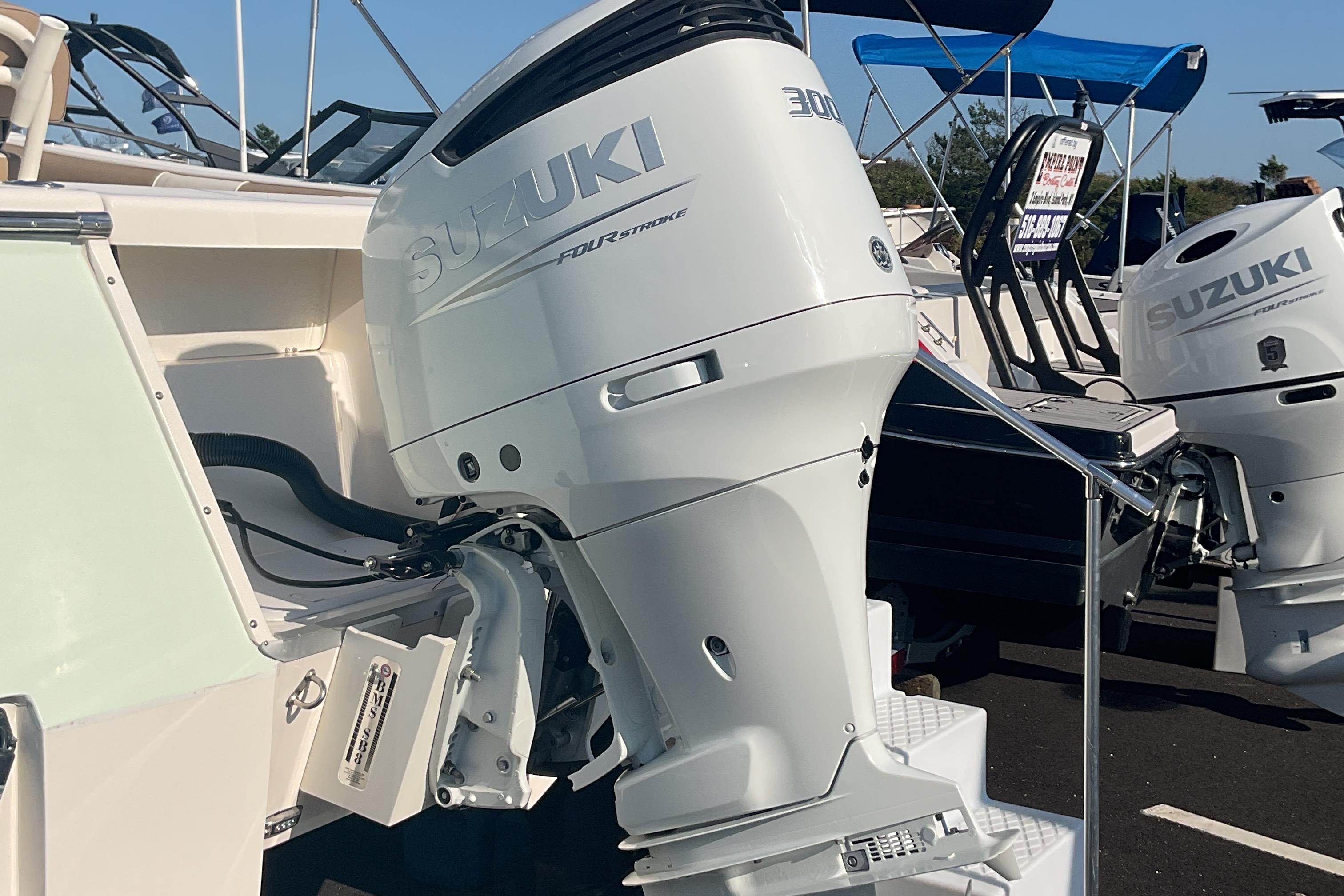 2023 Sea Born SX239 Offshore with Suzuki outboard motor, displayed at a boat show.
