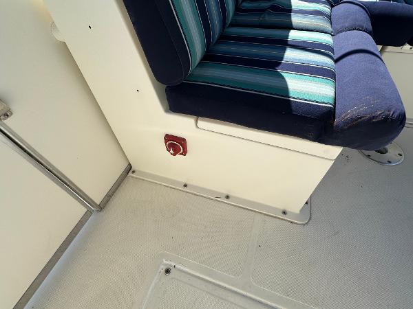 Interior of a 2020 Beachcat 20 boat with striped seating and a red switch.