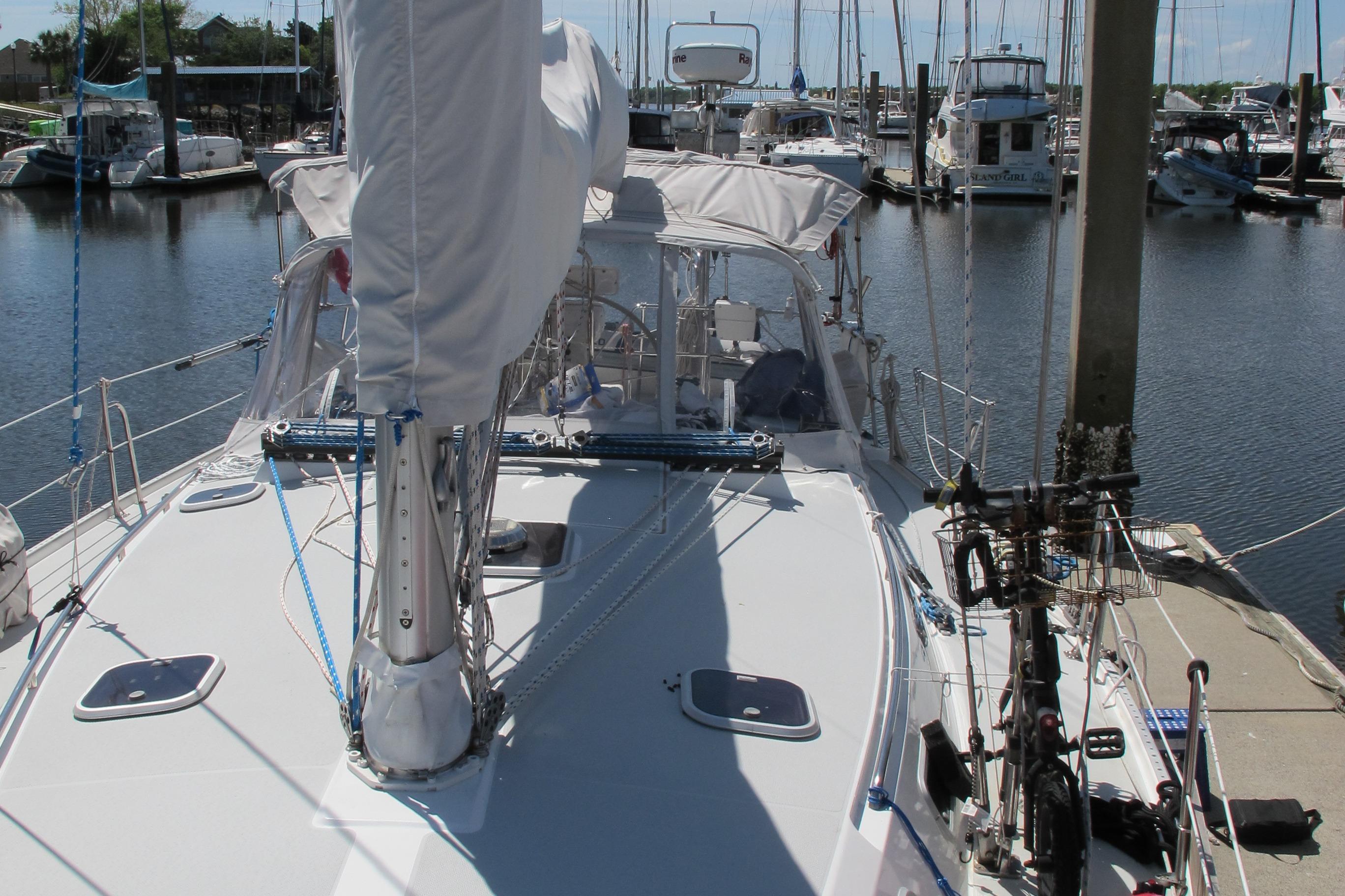 Sailboat Catalina 42 MkII, 1997 model, docked in a marina with other boats.