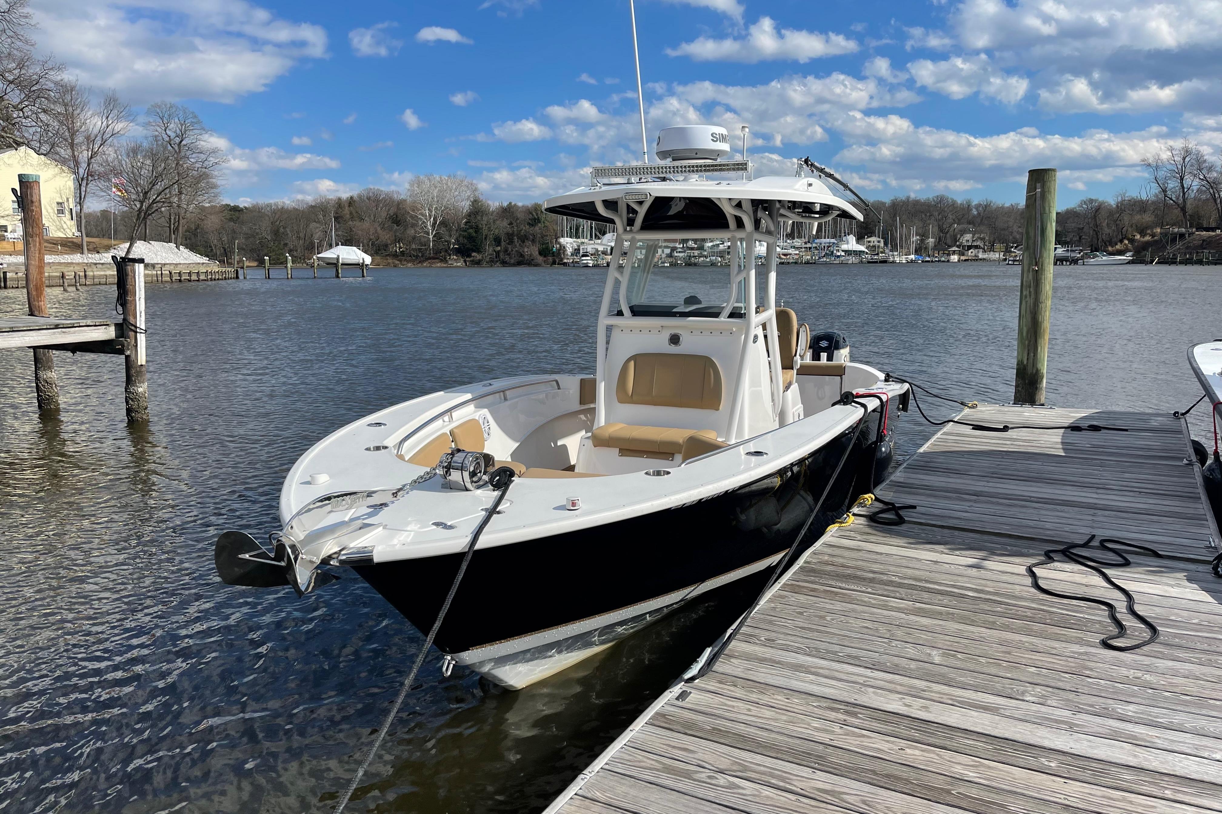 2019 Cape Horn 27 XS boat docked on a sunny day with blue skies.