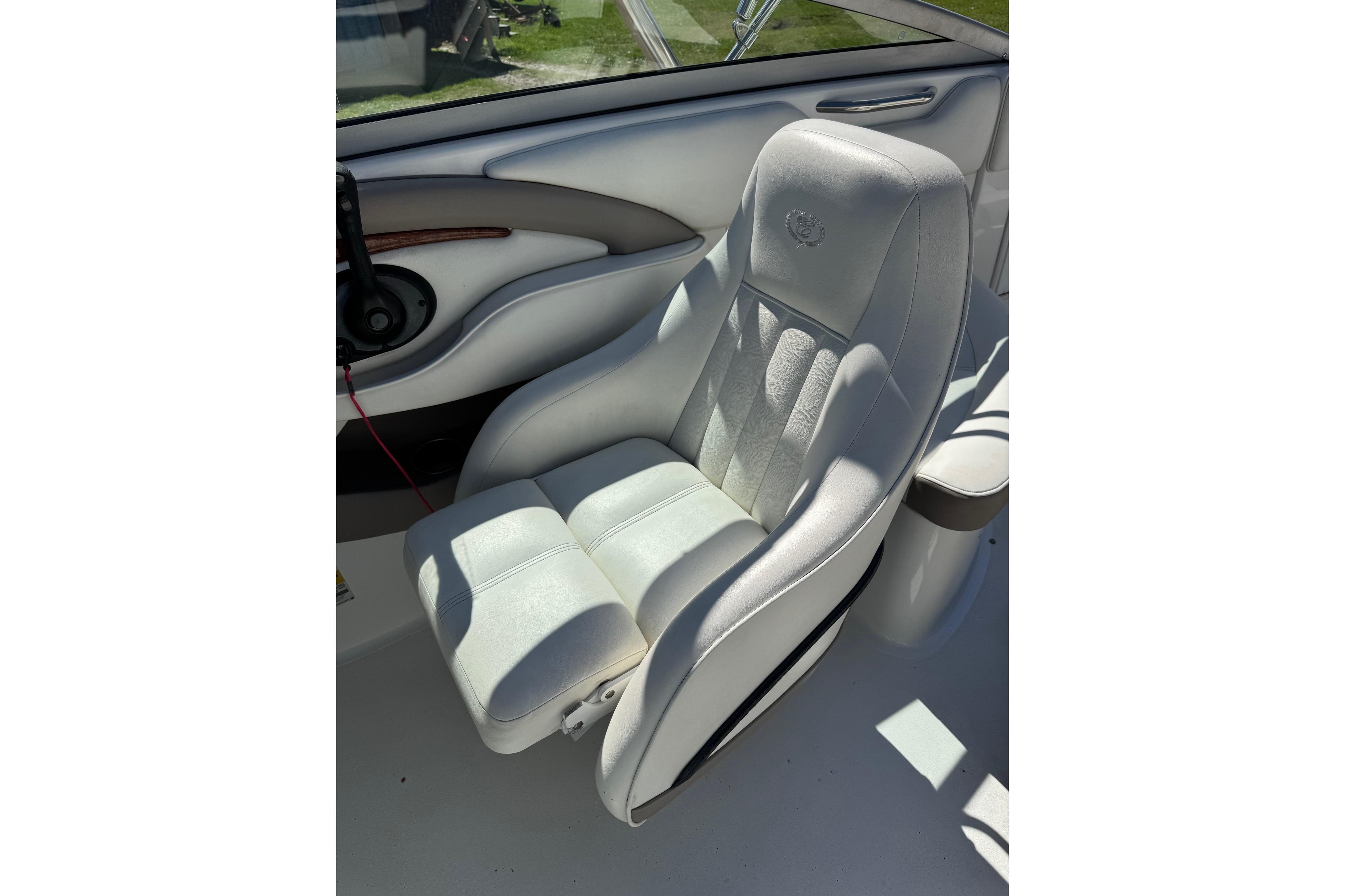 White leather seat in a 2005 Cobalt 240 boat, featuring elegant stitching.