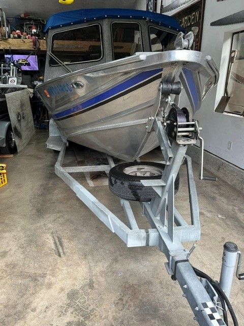 1986 Custom Jet Boat on trailer in garage.