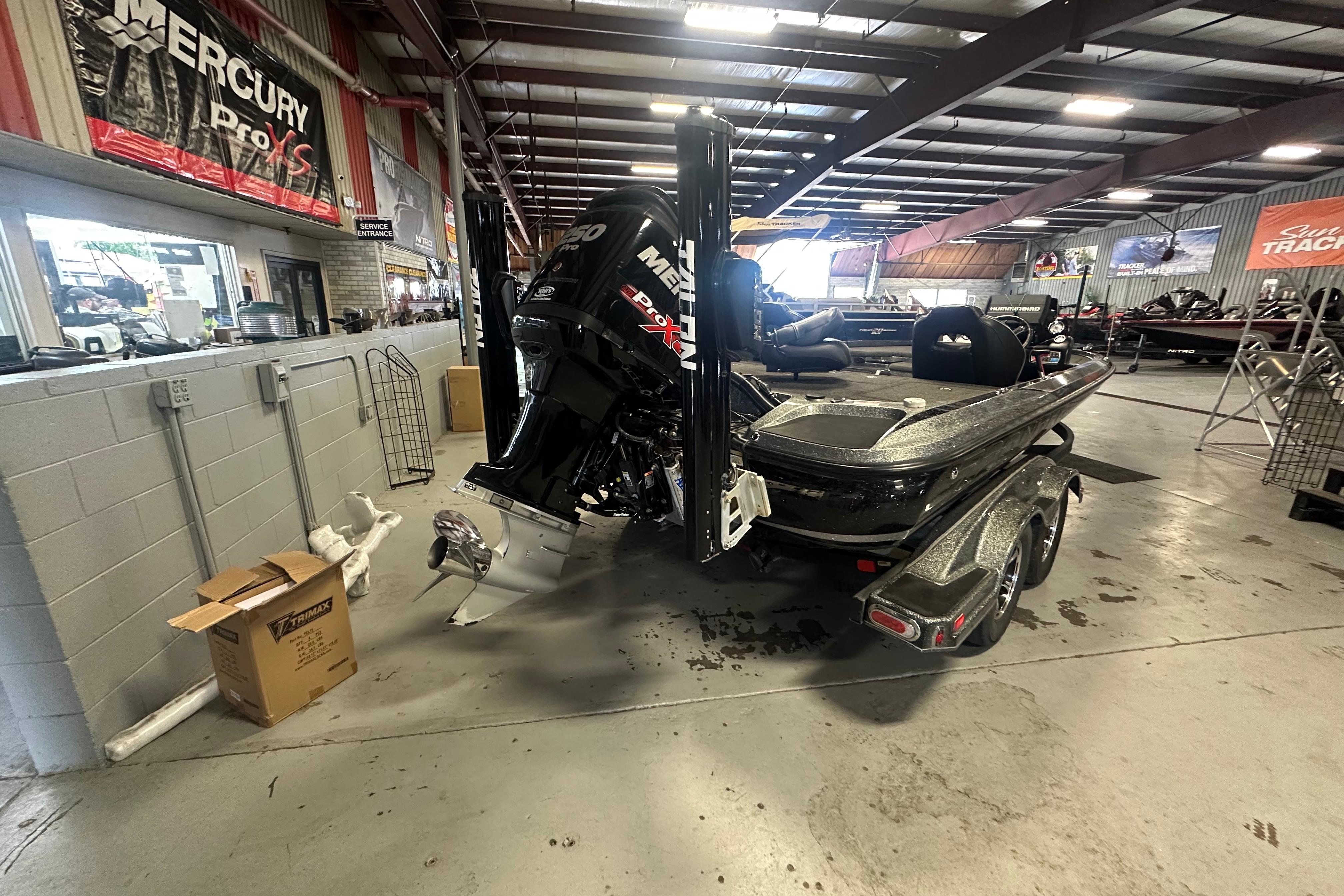 2018 Nitro Z20 Pro boat in showroom with Mercury engine display.